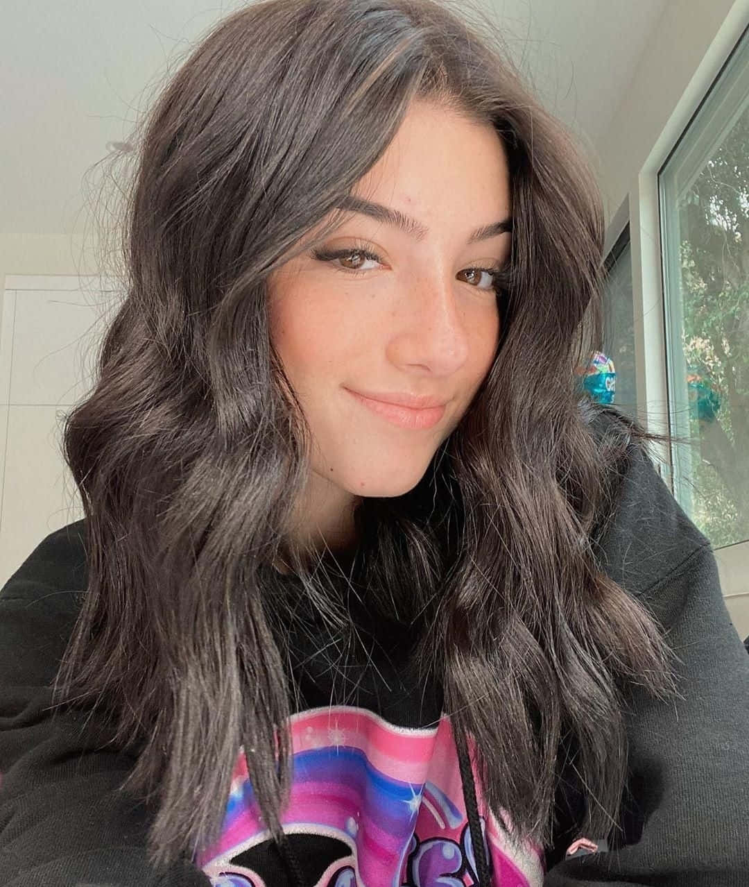 A Young Woman With Long Hair And A Black Sweatshirt Background