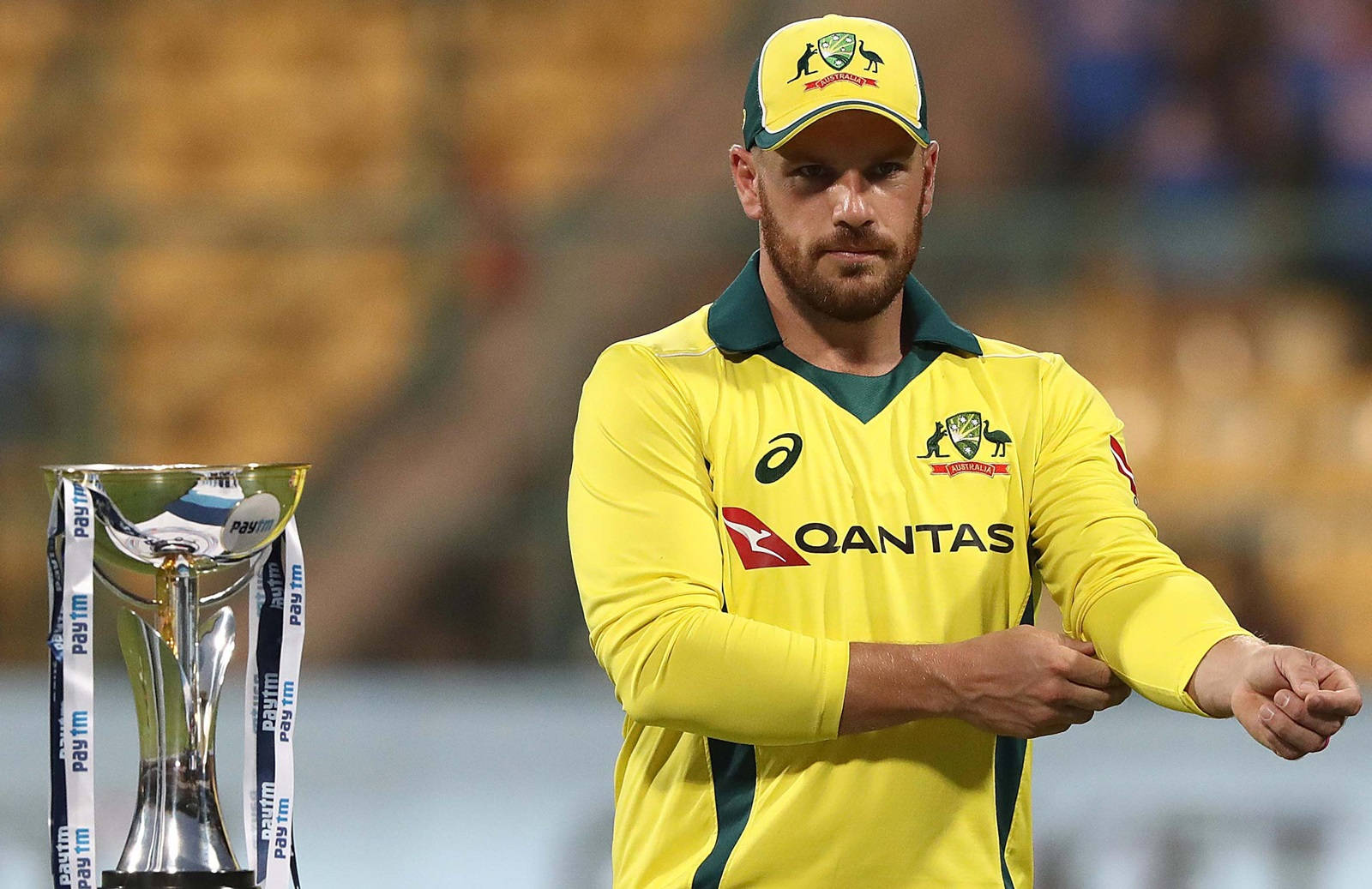 Aaron Finch Triumphantly Holds Championship Trophy Background