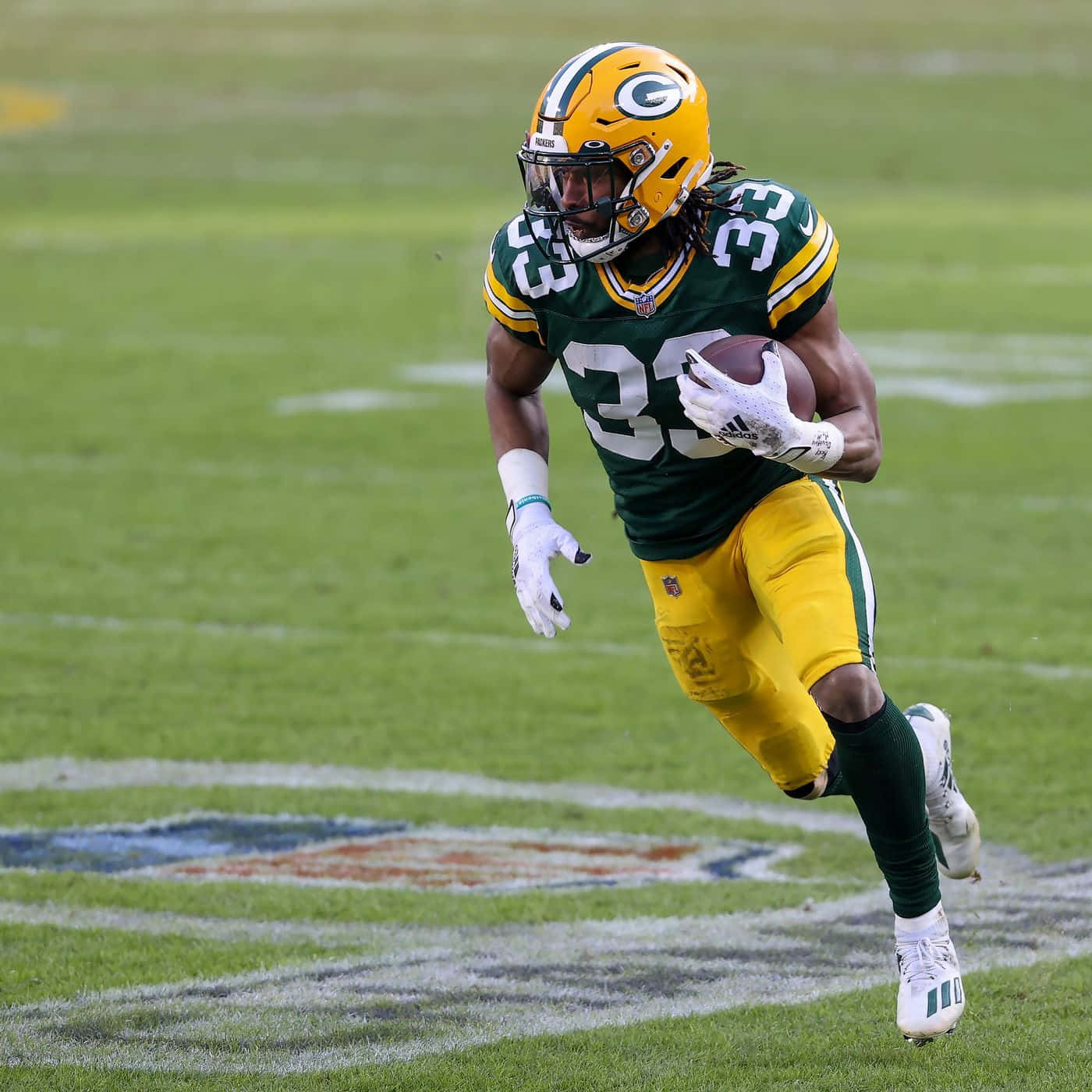 Aaron Jones #12 Of The Green Bay Packers Running With The Ball Background