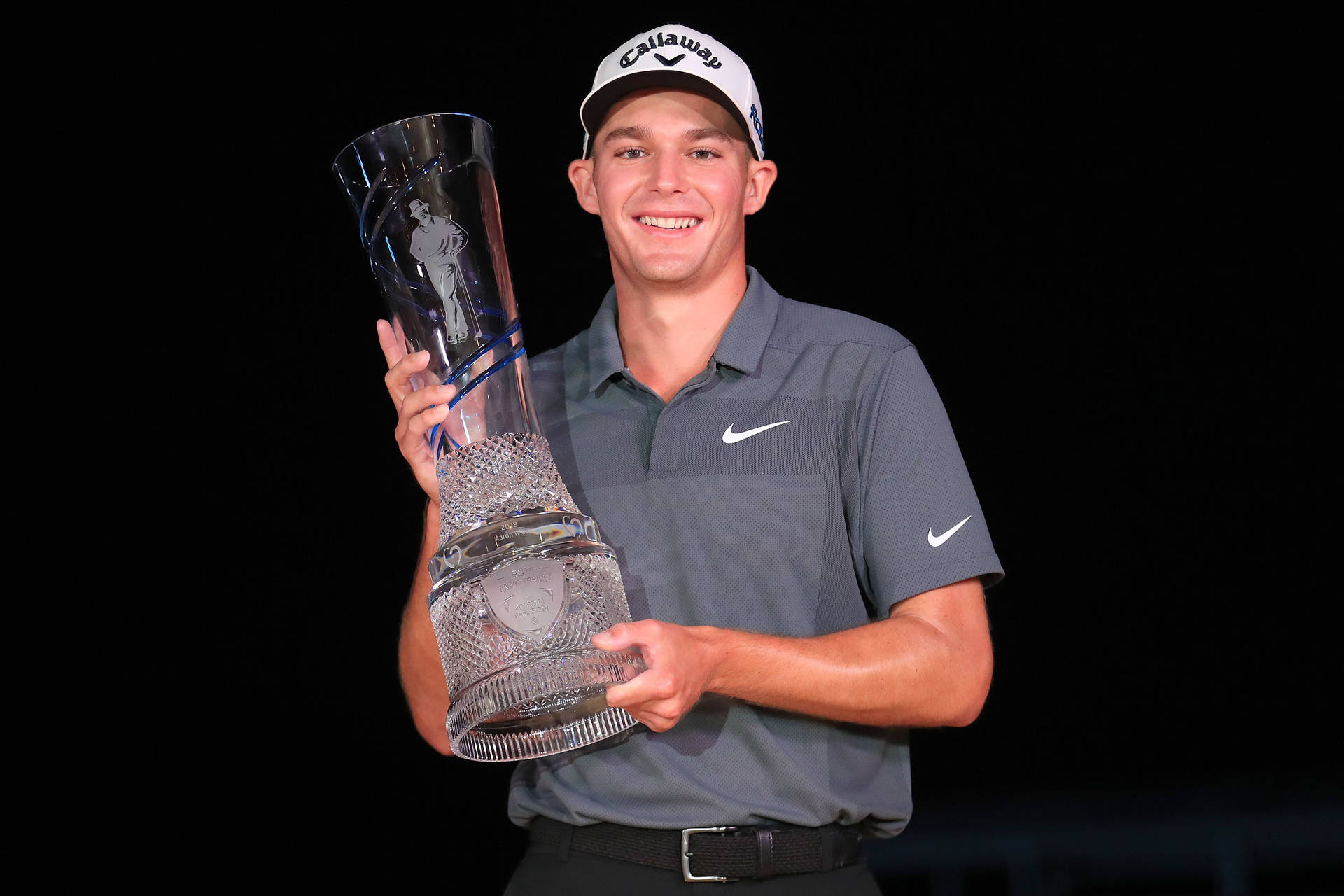 Aaron Wise Holding A Trophy Background