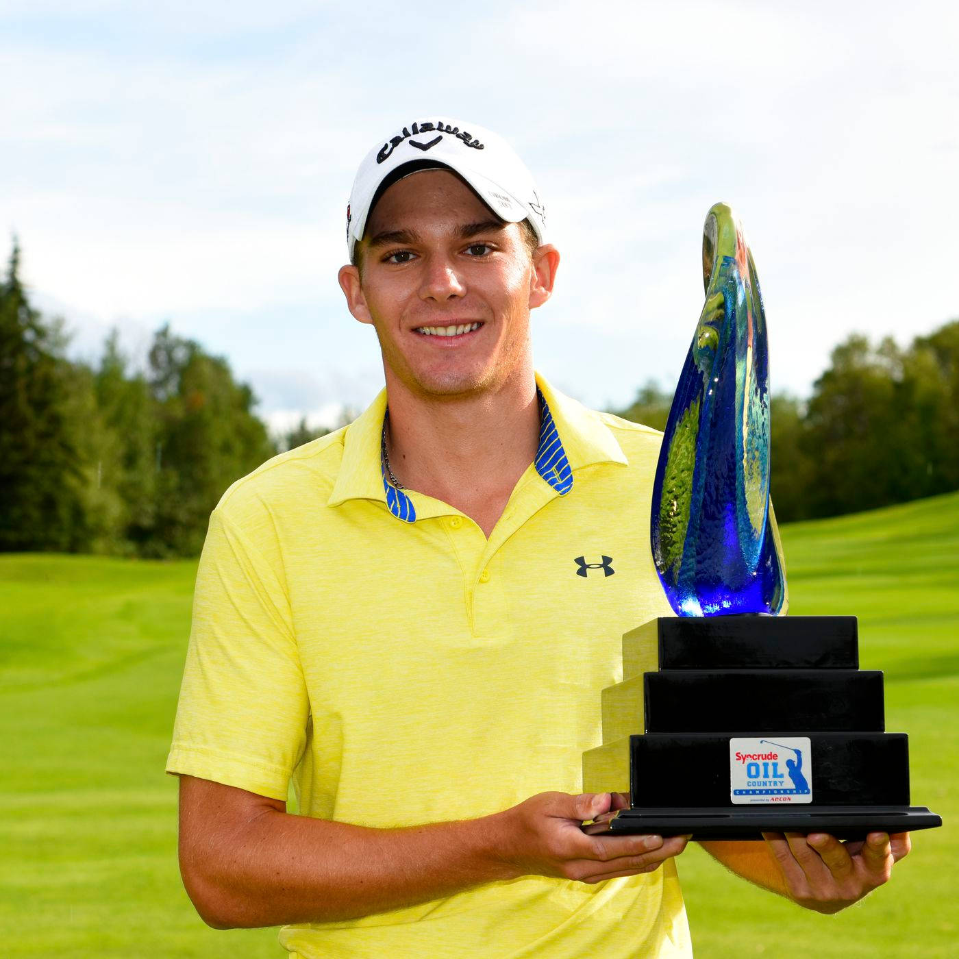 Aaron Wise Holding A Trophy Background