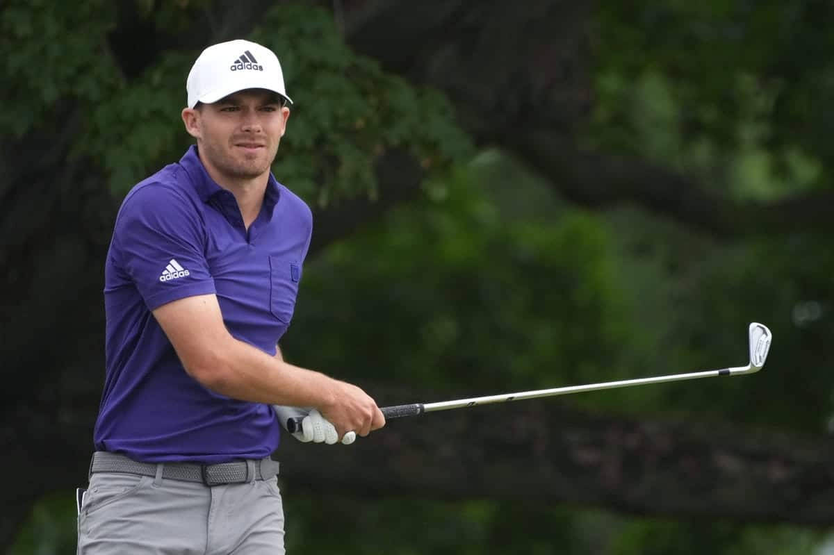 Aaron Wise Holding His Golf Club Background