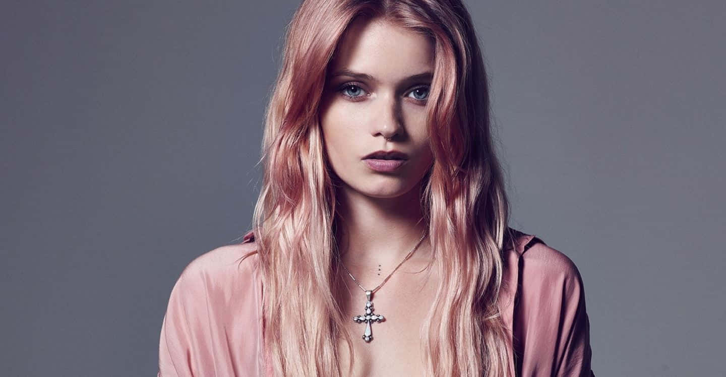 Abbey Lee Kershaw Posing Gracefully In A High-fashion Photoshoot Background