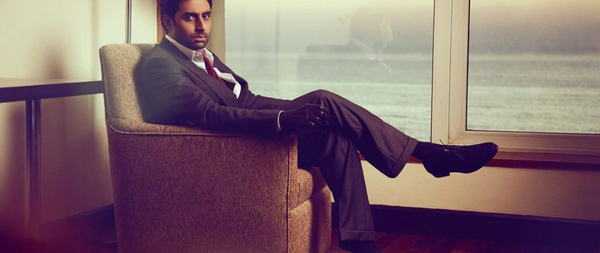 Abhishek Bachchan Sitting On Sofa Background