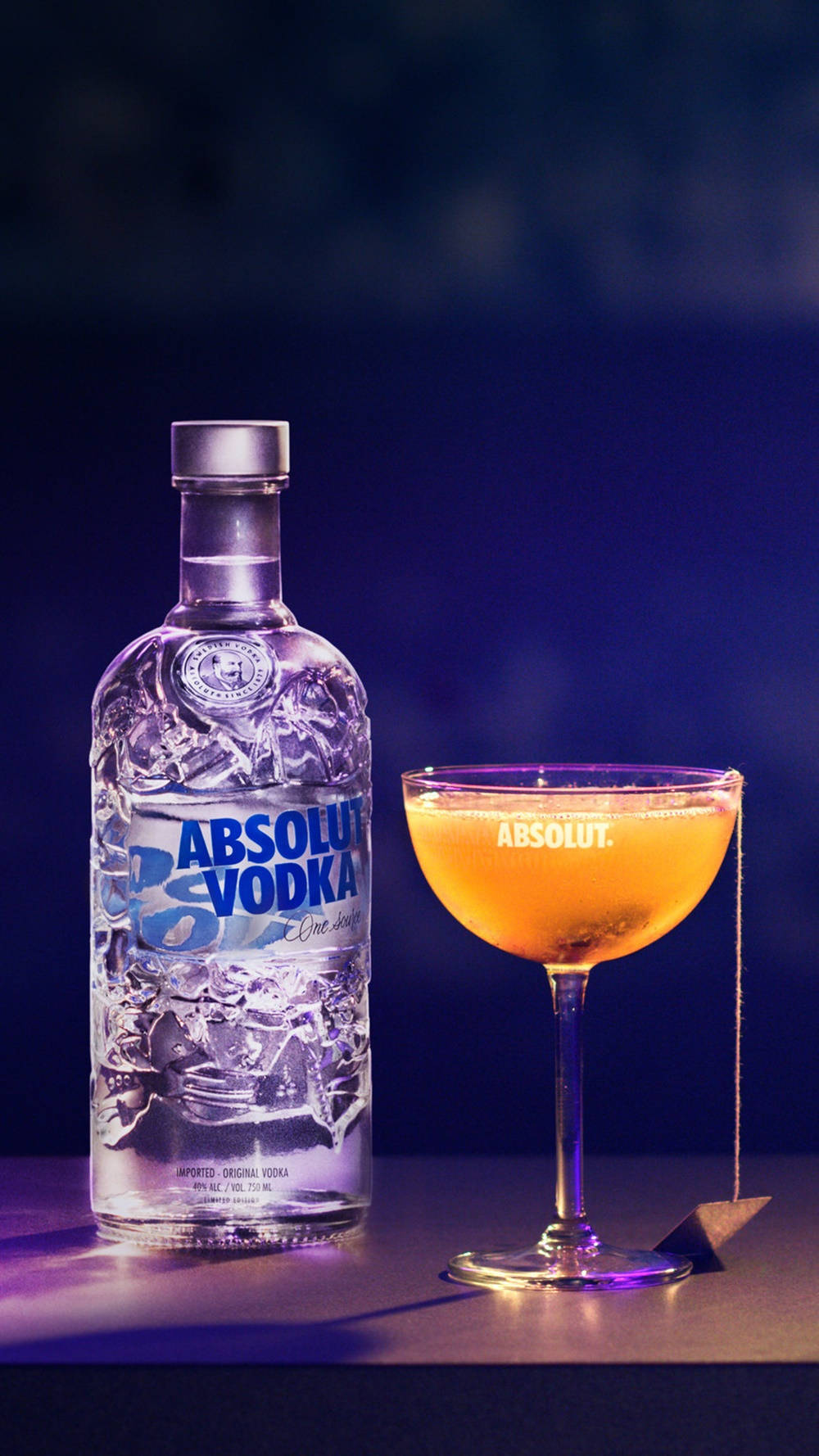 Absolut Vodka Bottle And Glass With Orange Cocktail