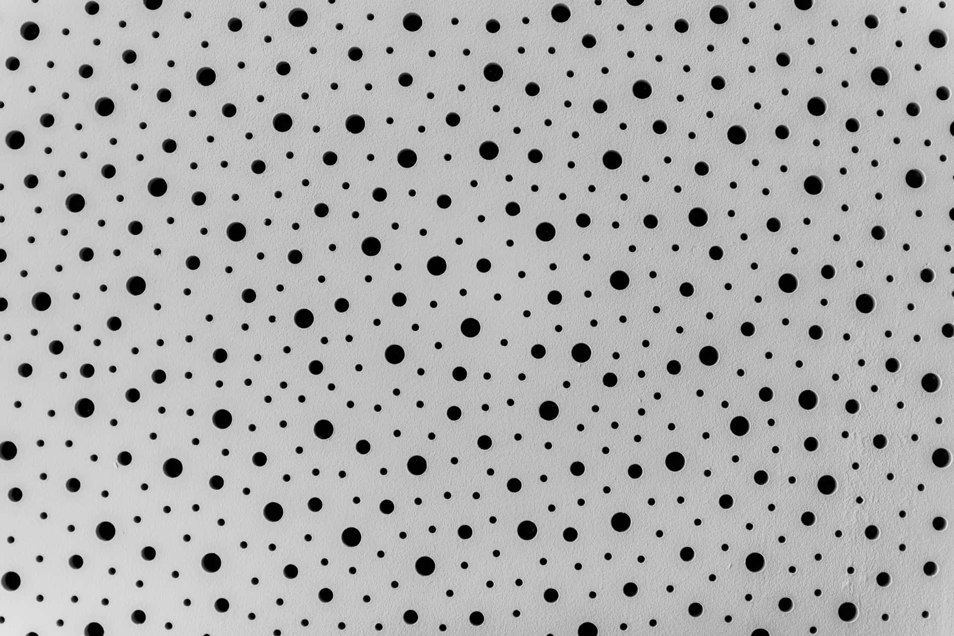 Abstract Artwork Of Black Dots On A White Canvas Background