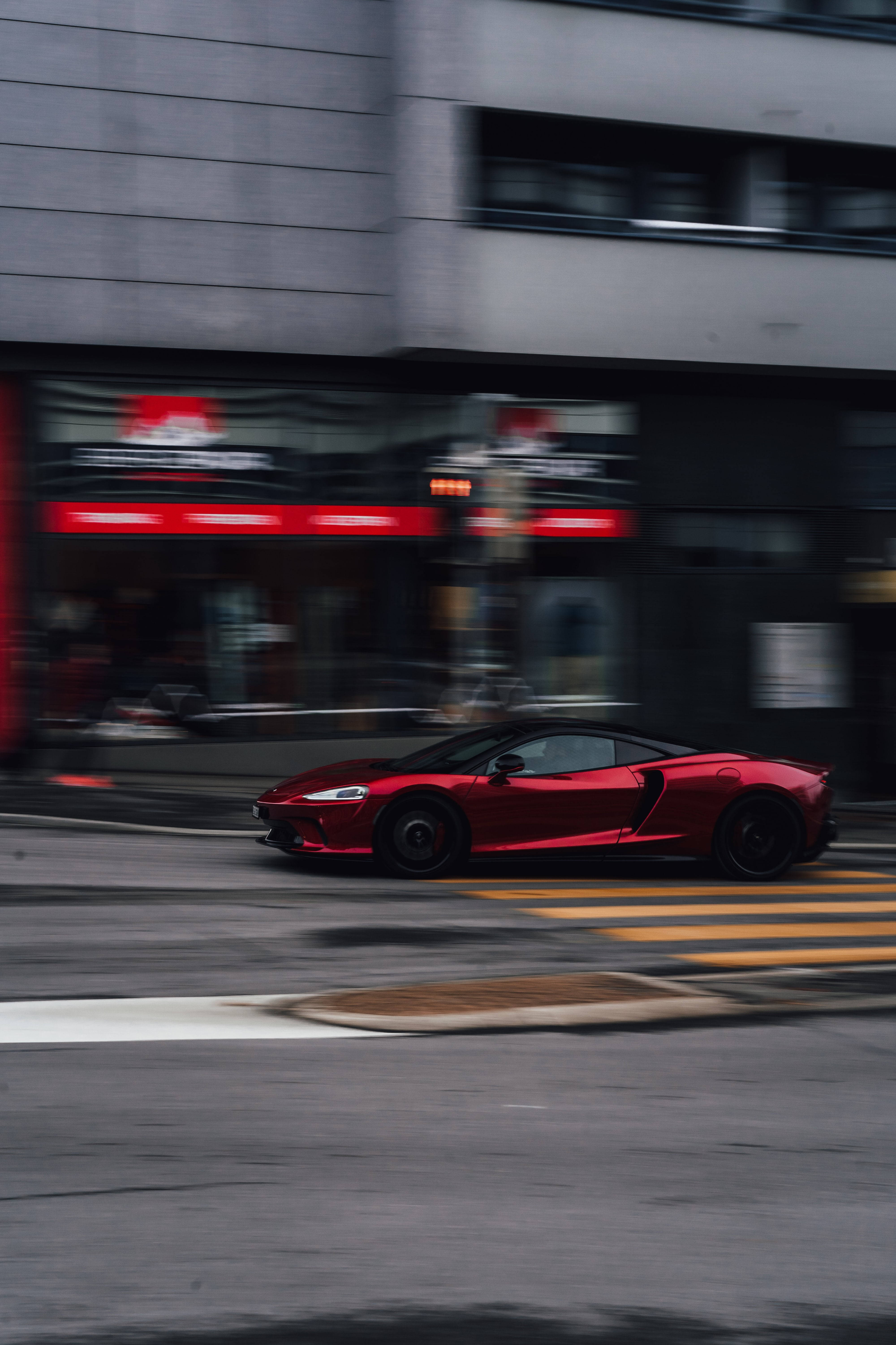 Accelerating Red And Black Sports Car Background