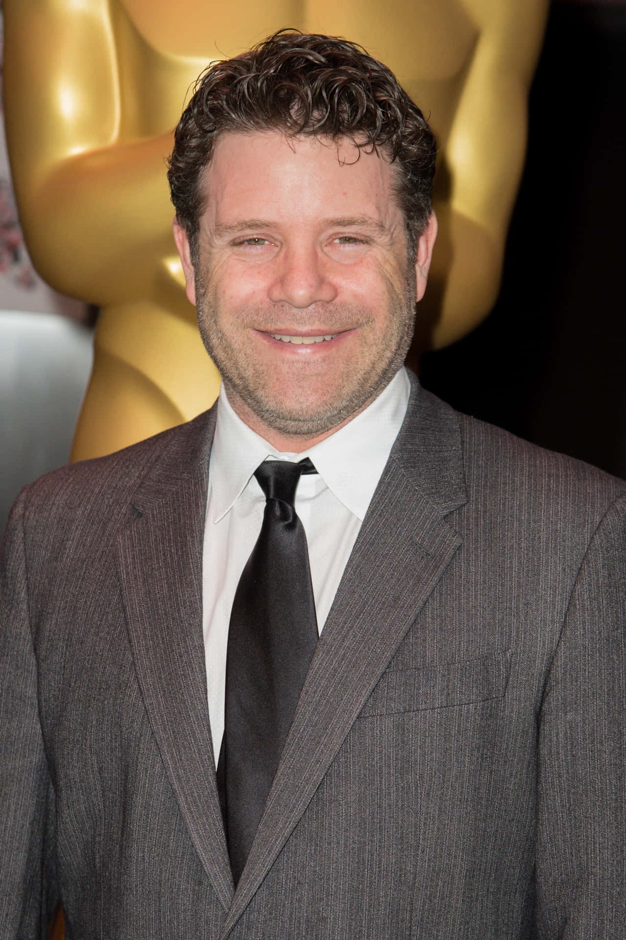 Acclaimed Actor Sean Astin In Spotlight Background