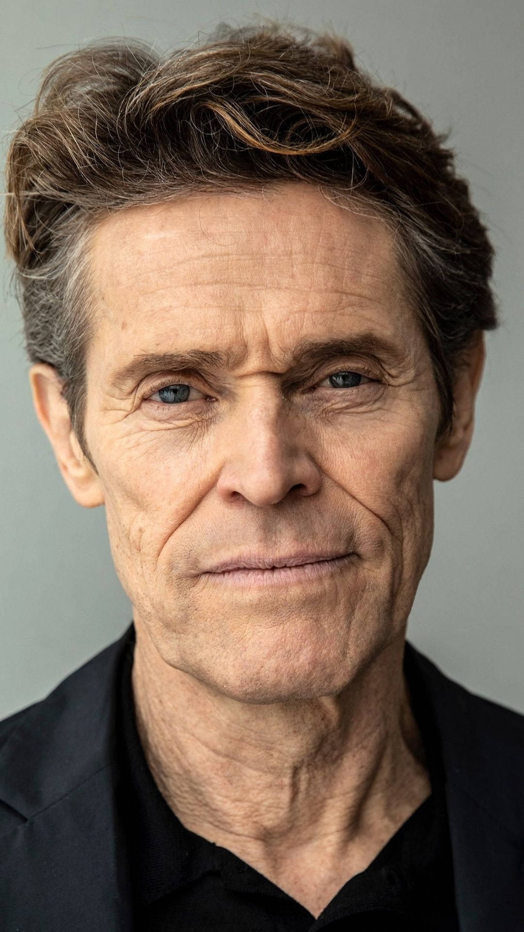 Acclaimed Actor Willem Dafoe In A Close-up Portrait Background