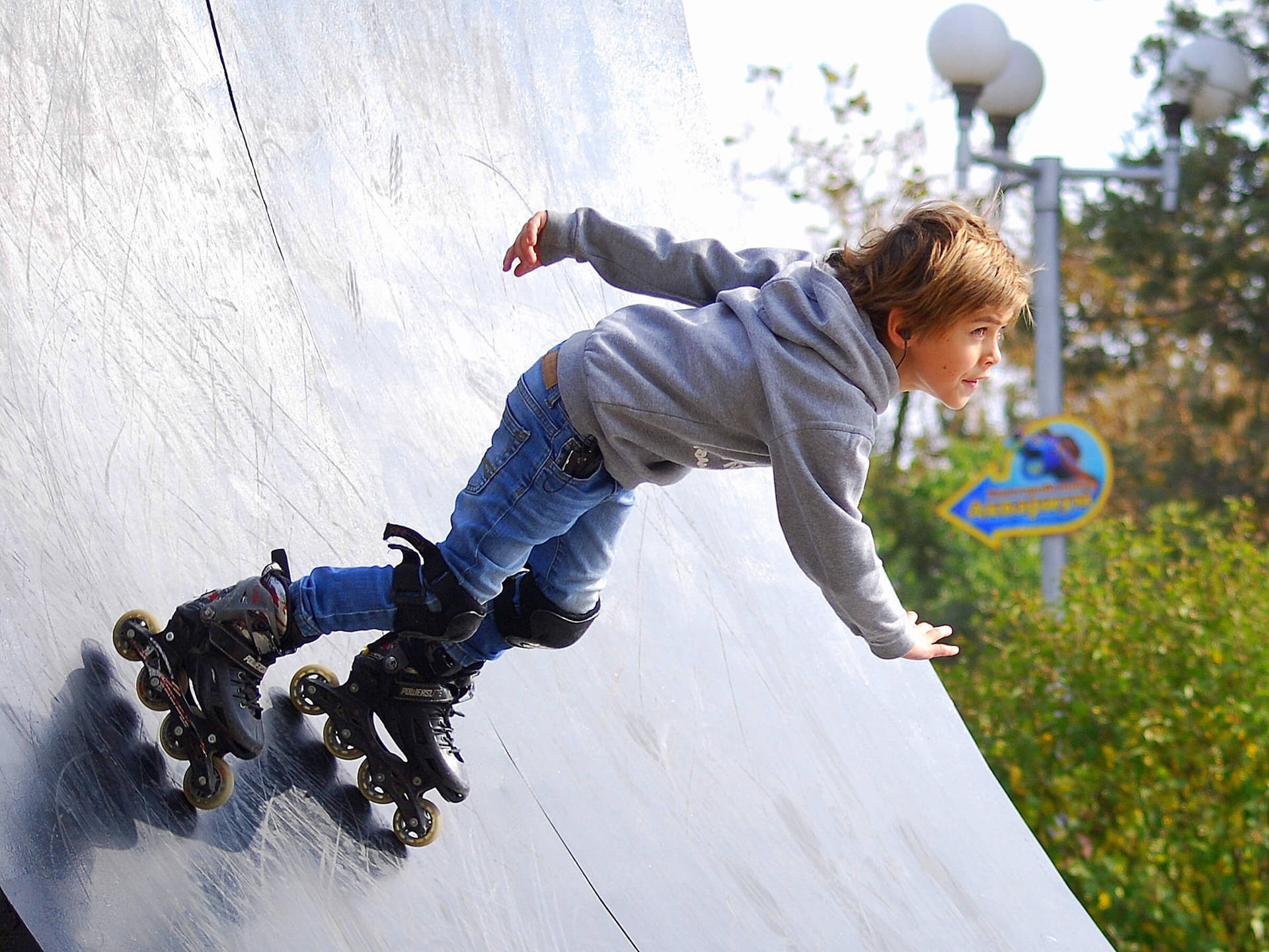 Active Young Boy Enjoying A Day Rollerblading