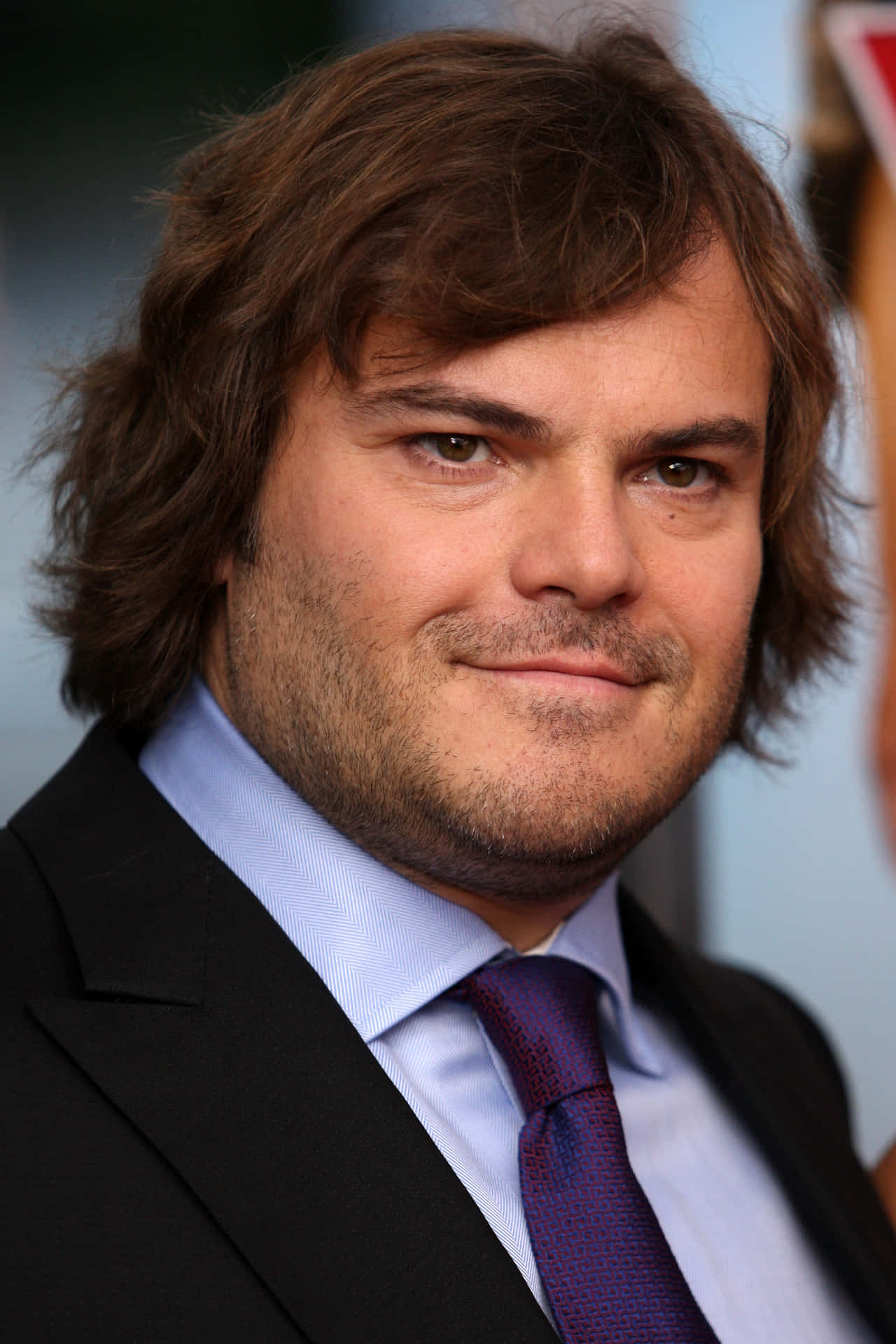 Actor And Comedian Jack Black Wearing A Backwards Baseball Cap. Background