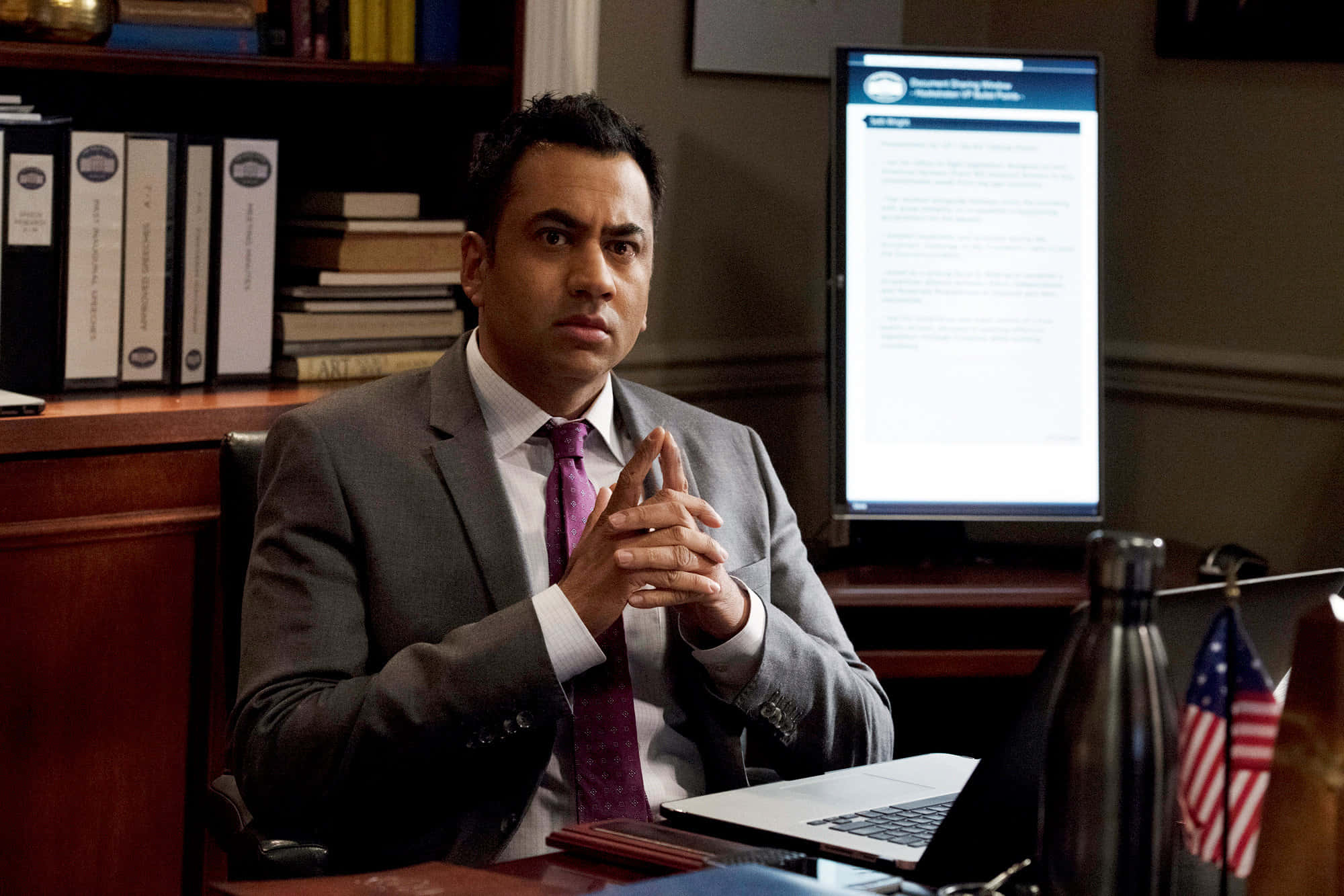Actor And Producer Kal Penn Smiles On The Red Carpet Background
