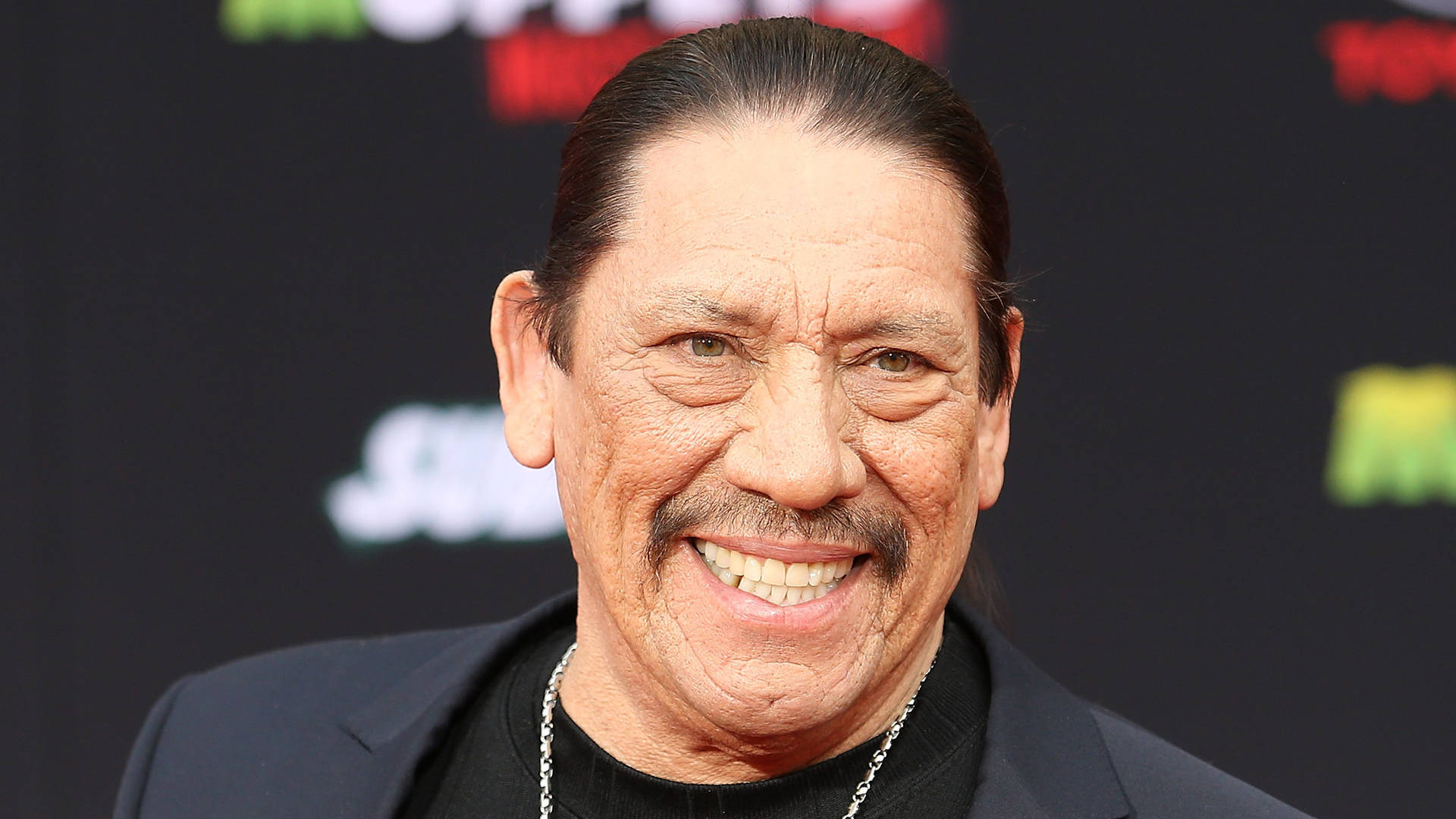 Actor Danny Trejo Smiling In Red Carpet