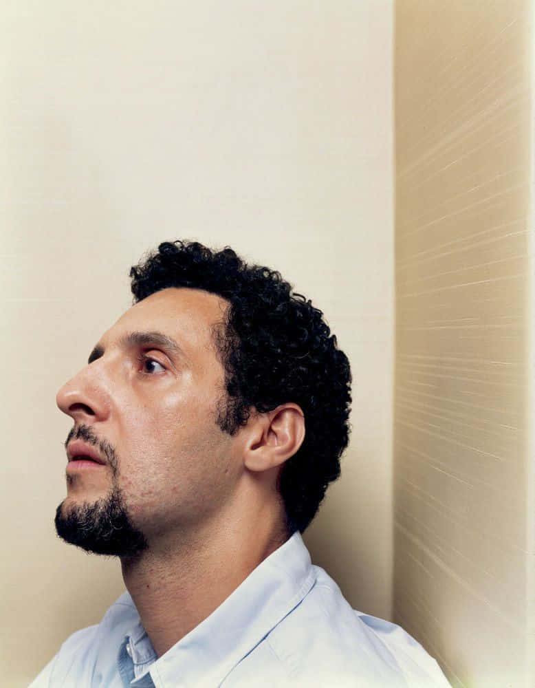 Actor John Turturro Looking Confidently Into The Future. Background