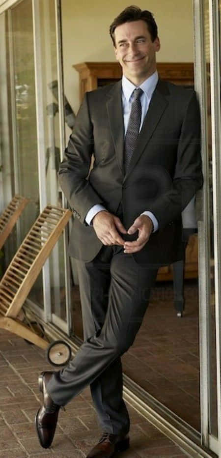 Actor Jon Hamm Looking Dapper In A Black Suit Background