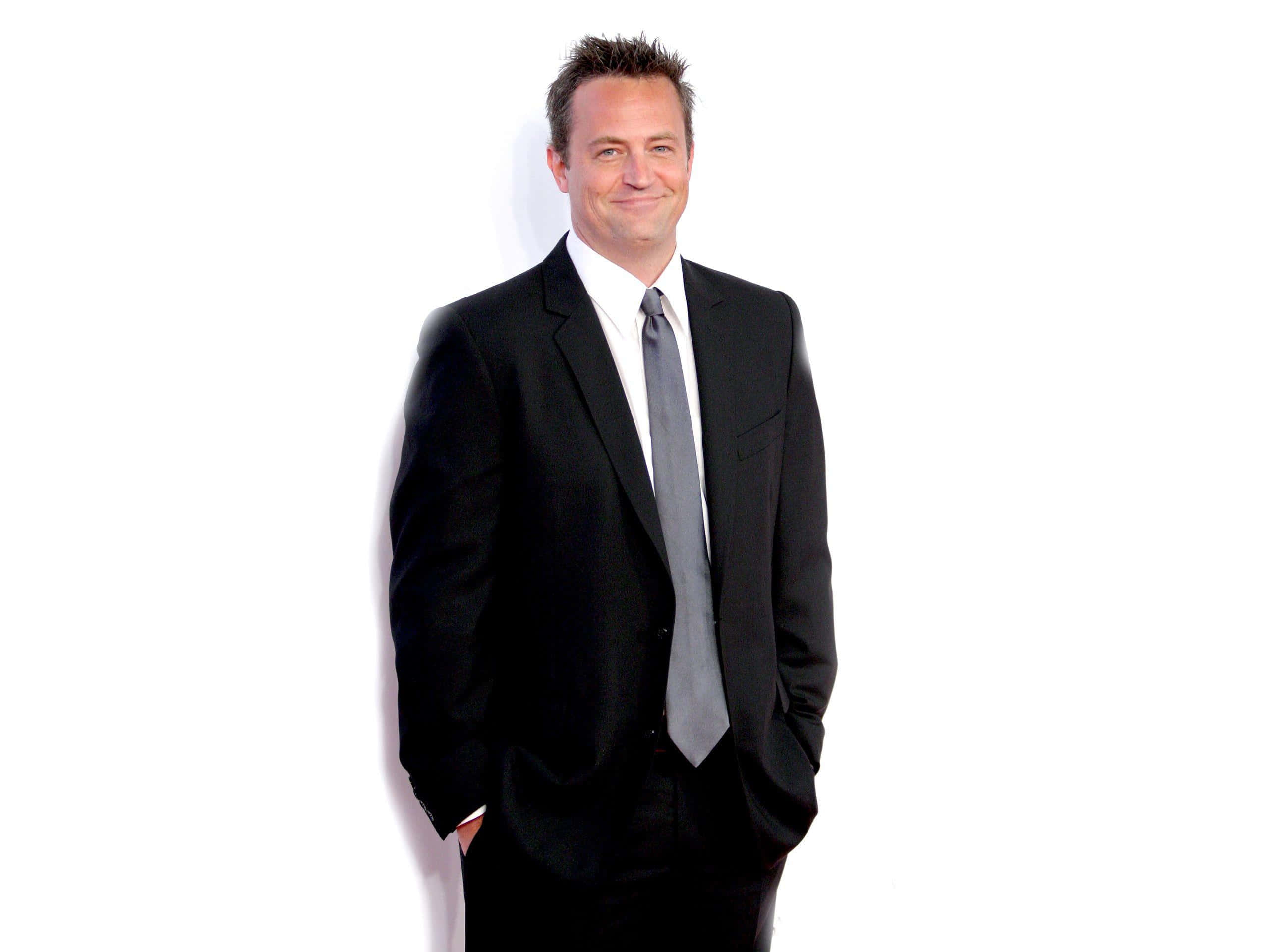 Actor Matthew Perry Poses In A Blue Suit Background