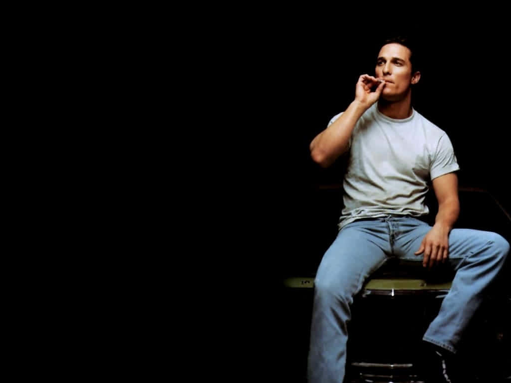 Actor Matthew Perry Stands Before A Brick Wall In An Artsy Photo.