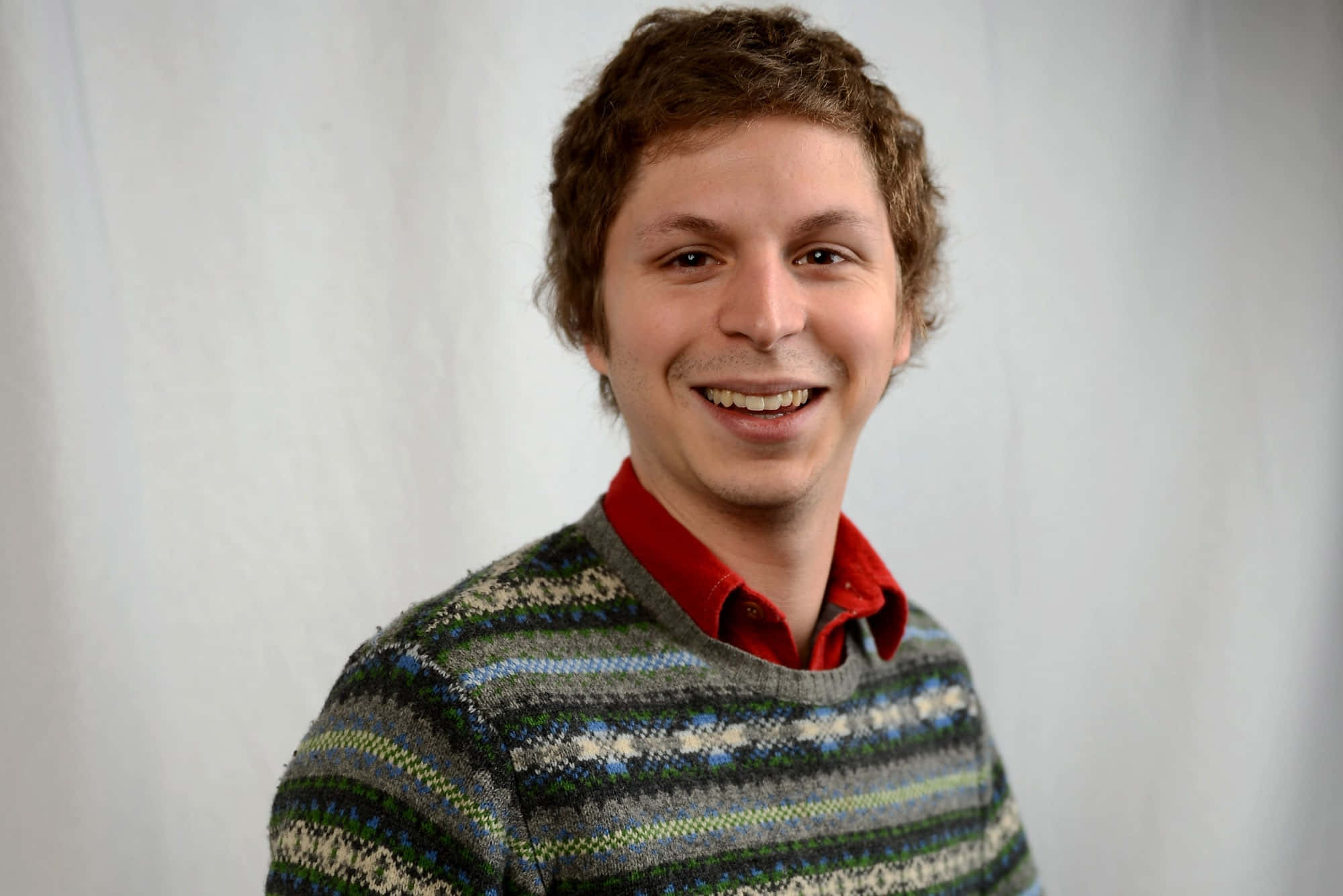 Actor Michael Cera Poses With A Guitar Background