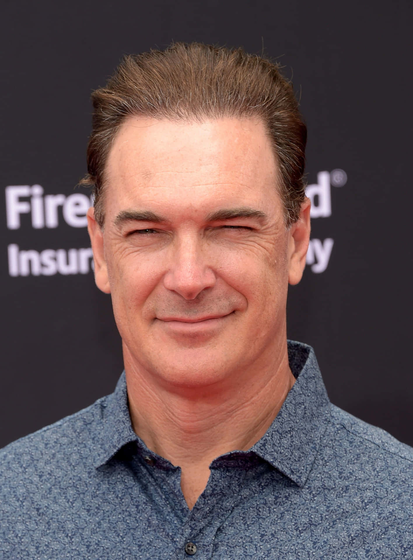 Actor Patrick Warburton Smiling Happily Background