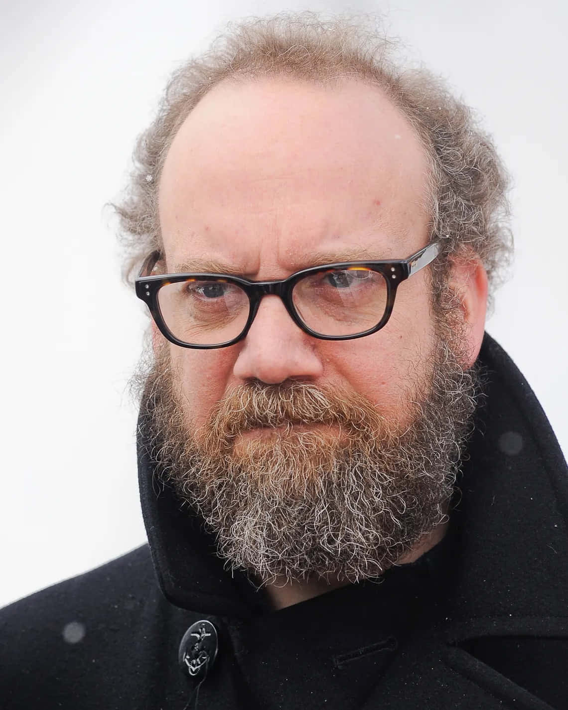 Actor Paul Giamatti Poses With A Cheeky Smirk. Background