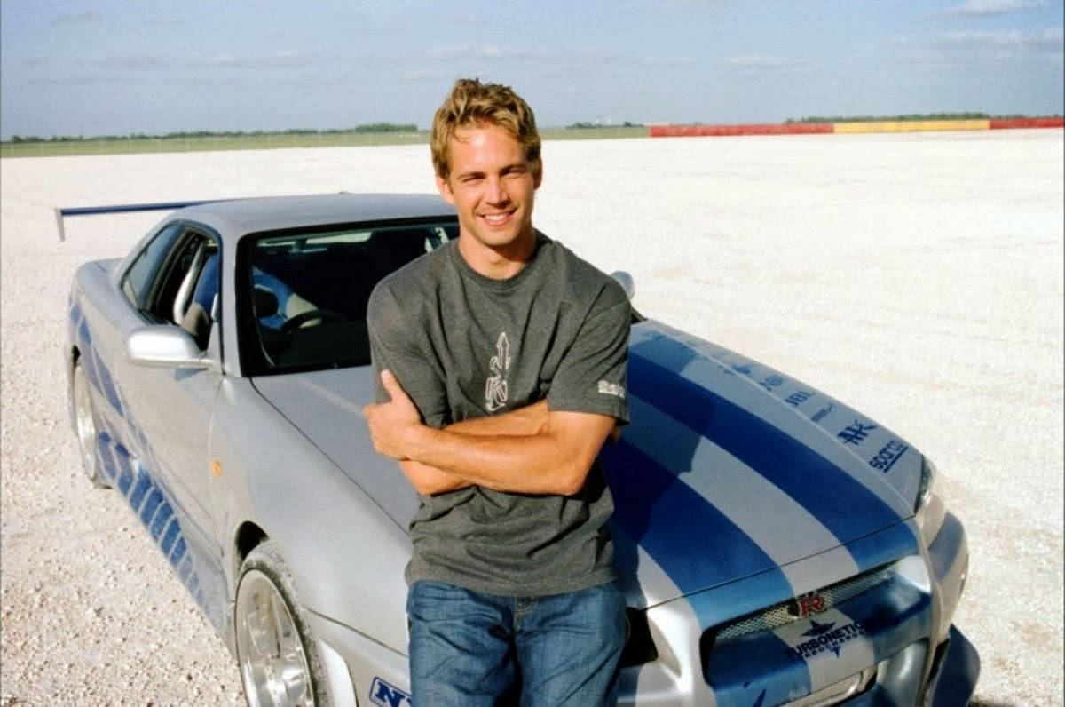 Actor Paul Walker In Front Of His Iconic Porsche Lykan Supercar. Background