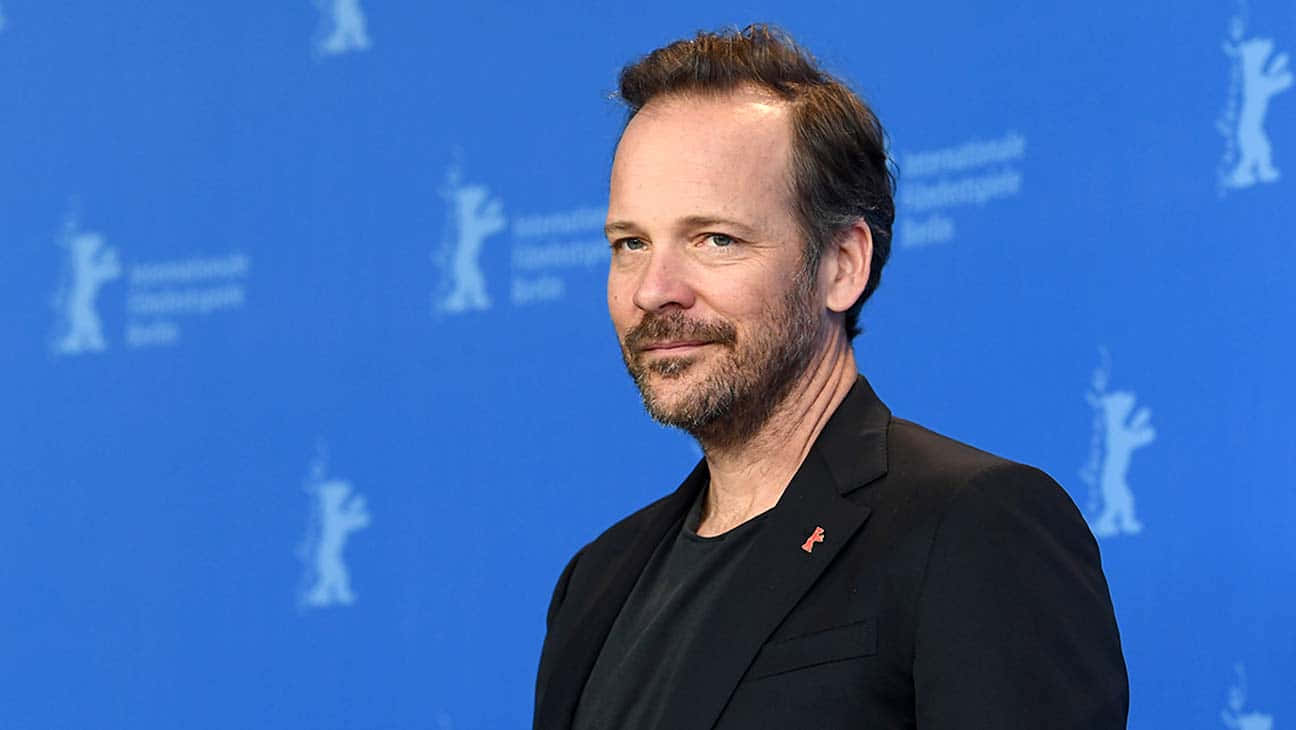 Actor Peter Sarsgaard Lighting Up The Screen Background