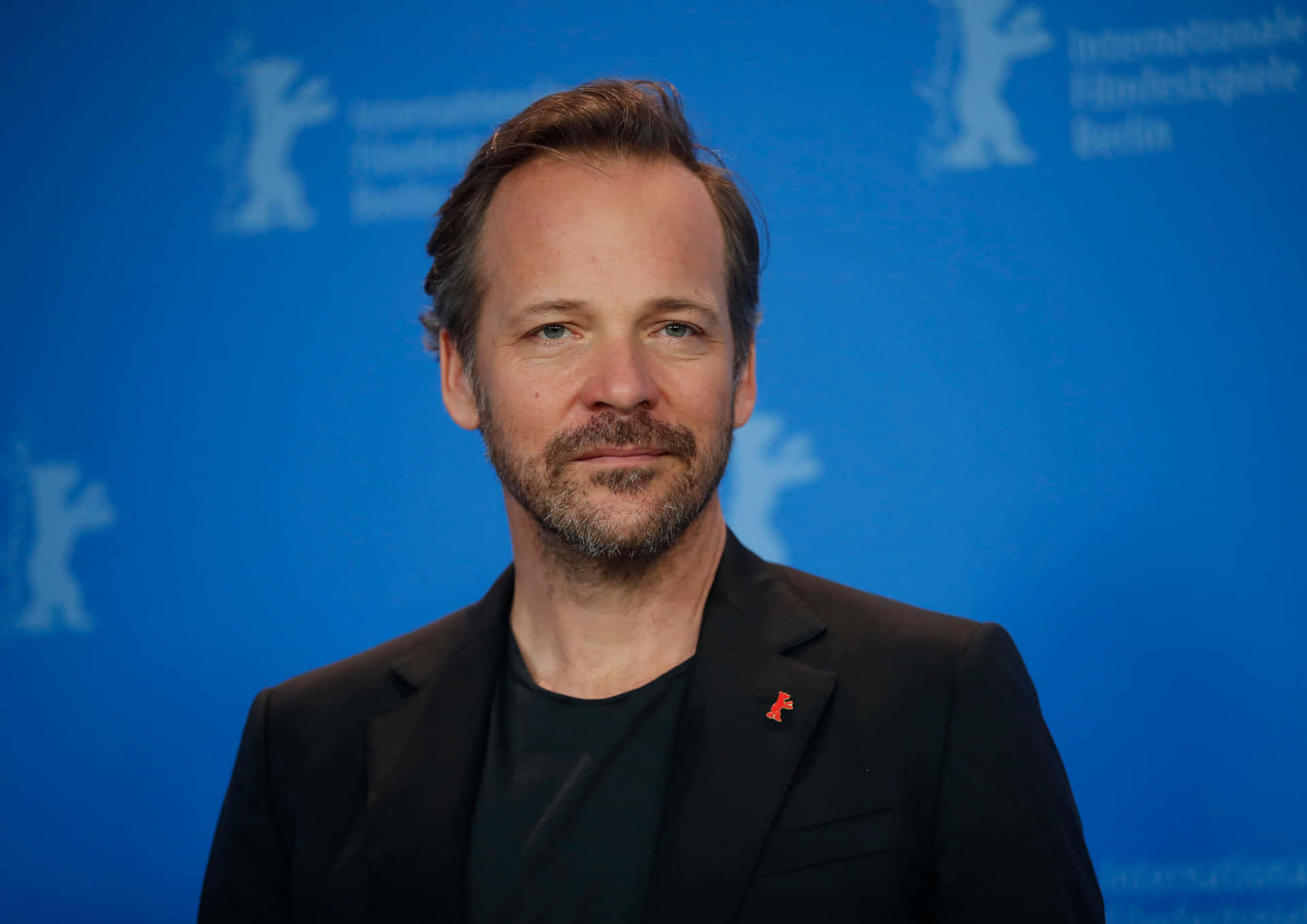 Actor Peter Sarsgaard Strikes A Thoughtful Pose Background