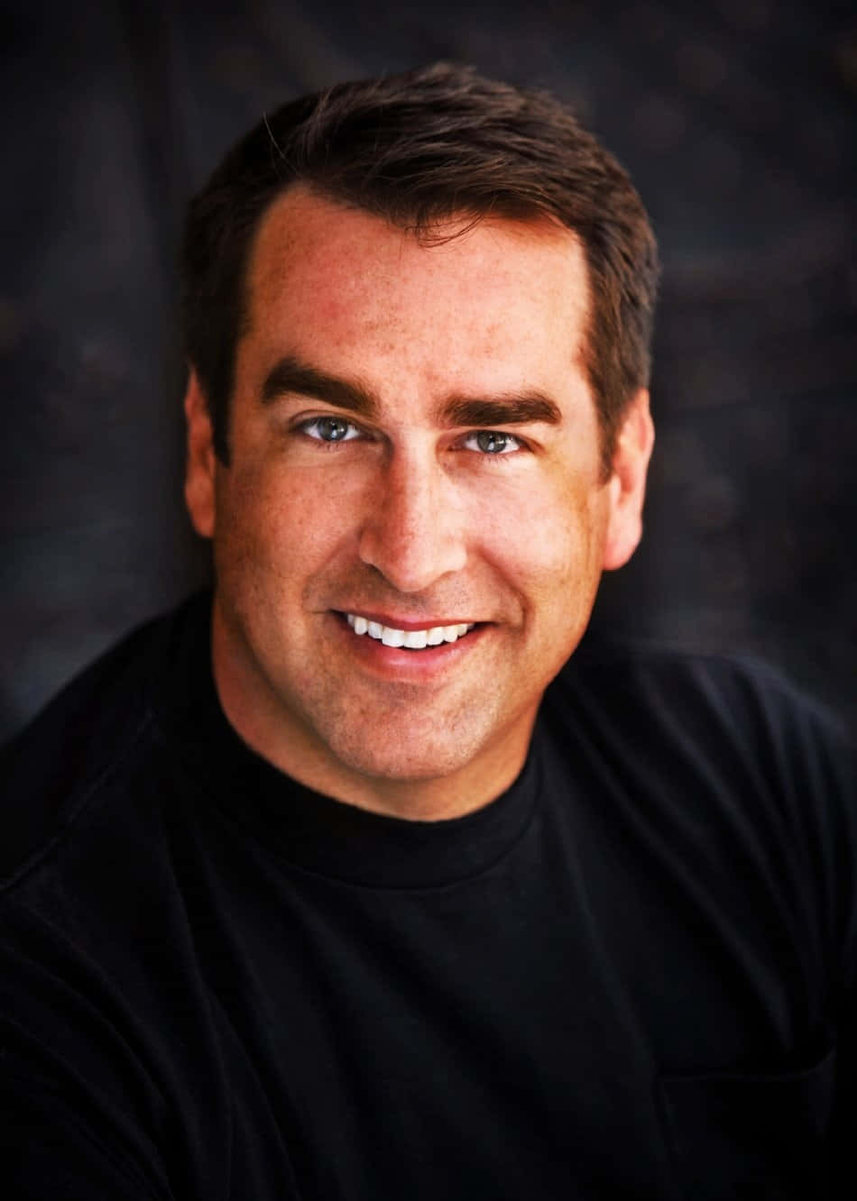 Actor Rob Riggle Smiles For The Camera Background