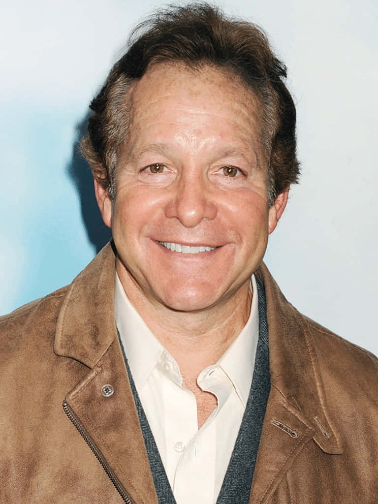 Actor Steve Guttenberg Looking Dapper In A Grey Suit. Background