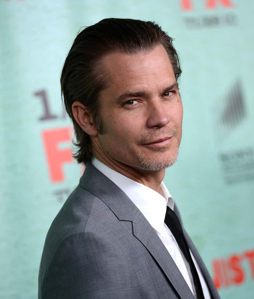 Actor Timothy Olyphant Striking A Pose In A Casual Outfit