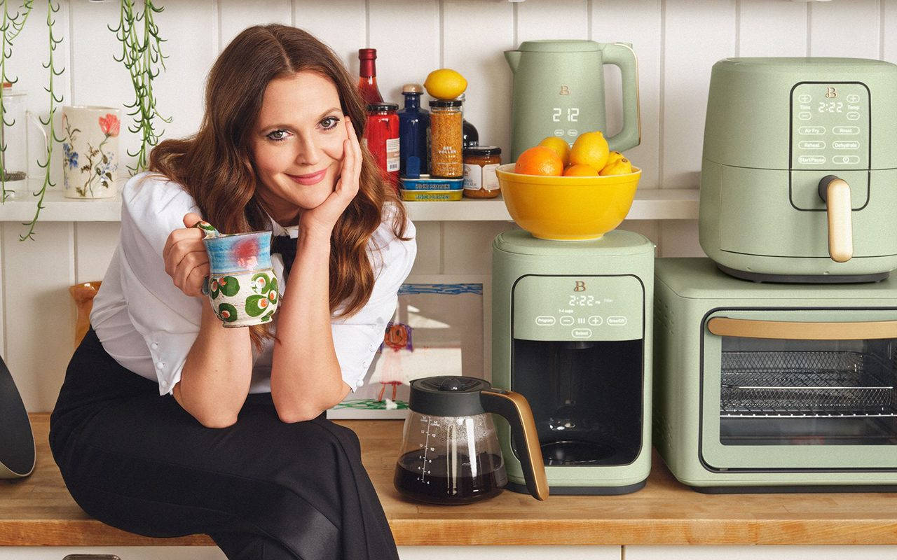 Actress Drew Barrymore In A Beautifully Designed Green Kitchen. Background