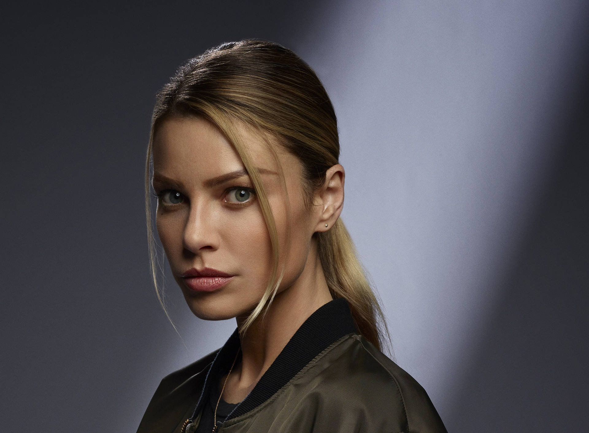 Actress Lauren German Strikes A Stunning And Charismatic Pose. Background