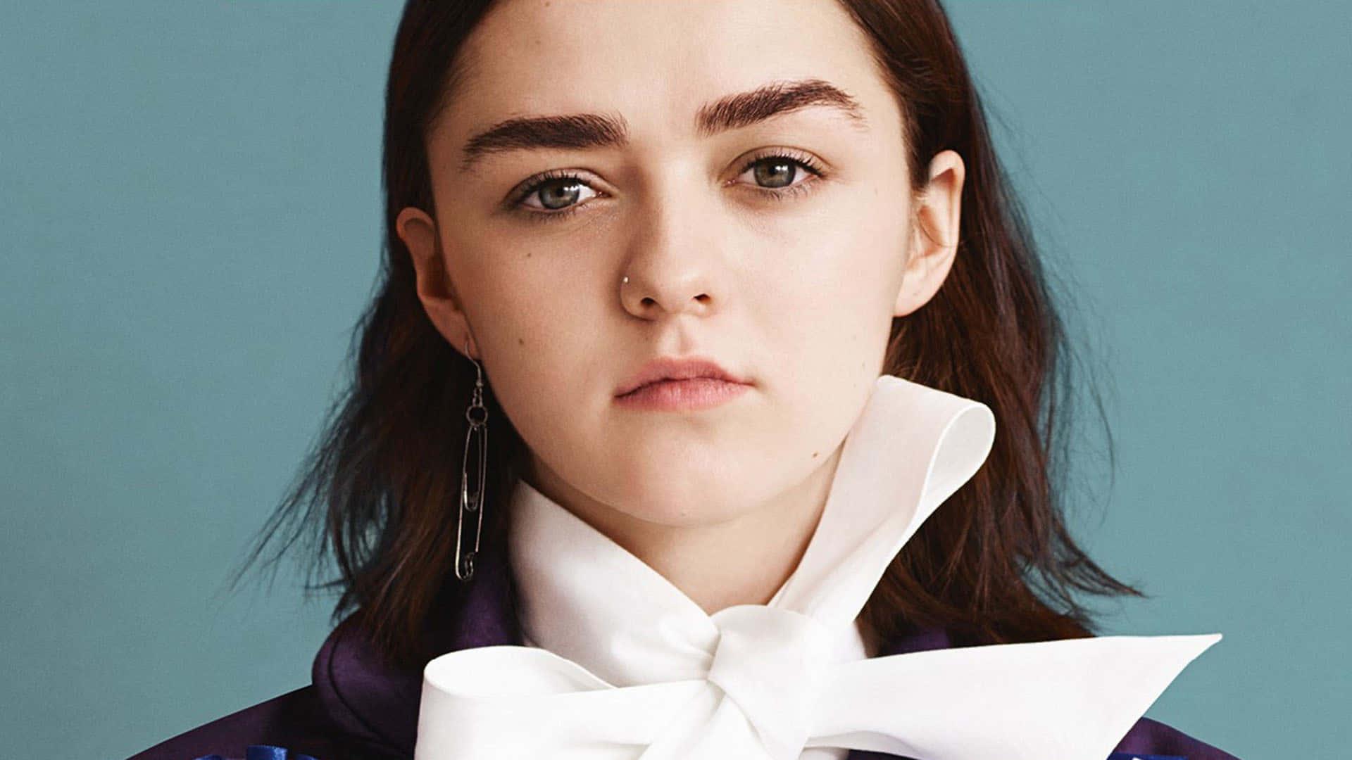 Actress Maisie Williams Posing With A Brilliant Smile Background