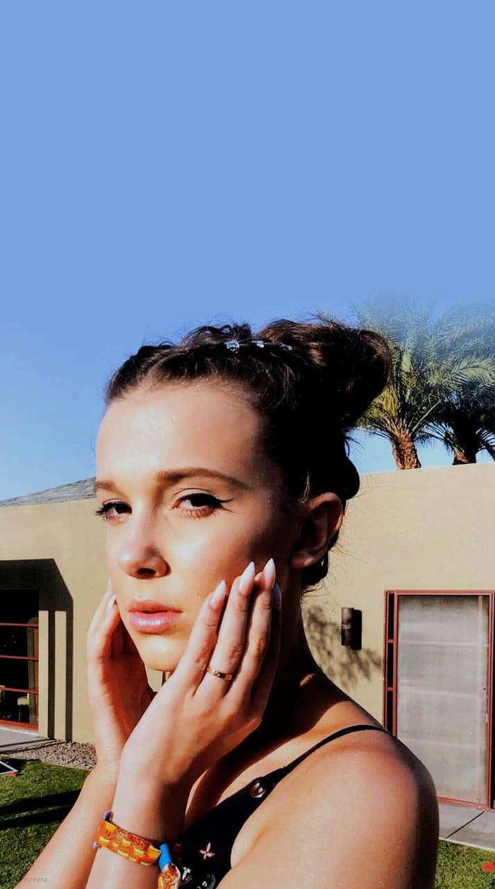 Actress Millie Bobby Brown Enjoying The Summer Season In Style Background