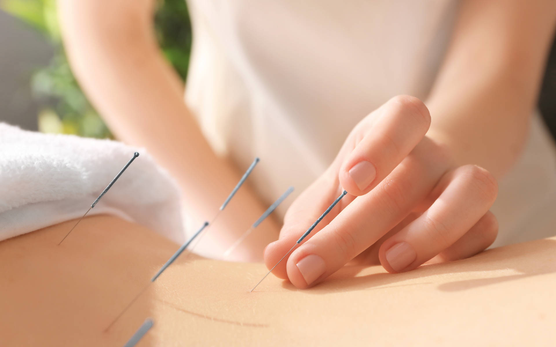 Acupuncturist Inserting Needle Into Patient's Skin Background