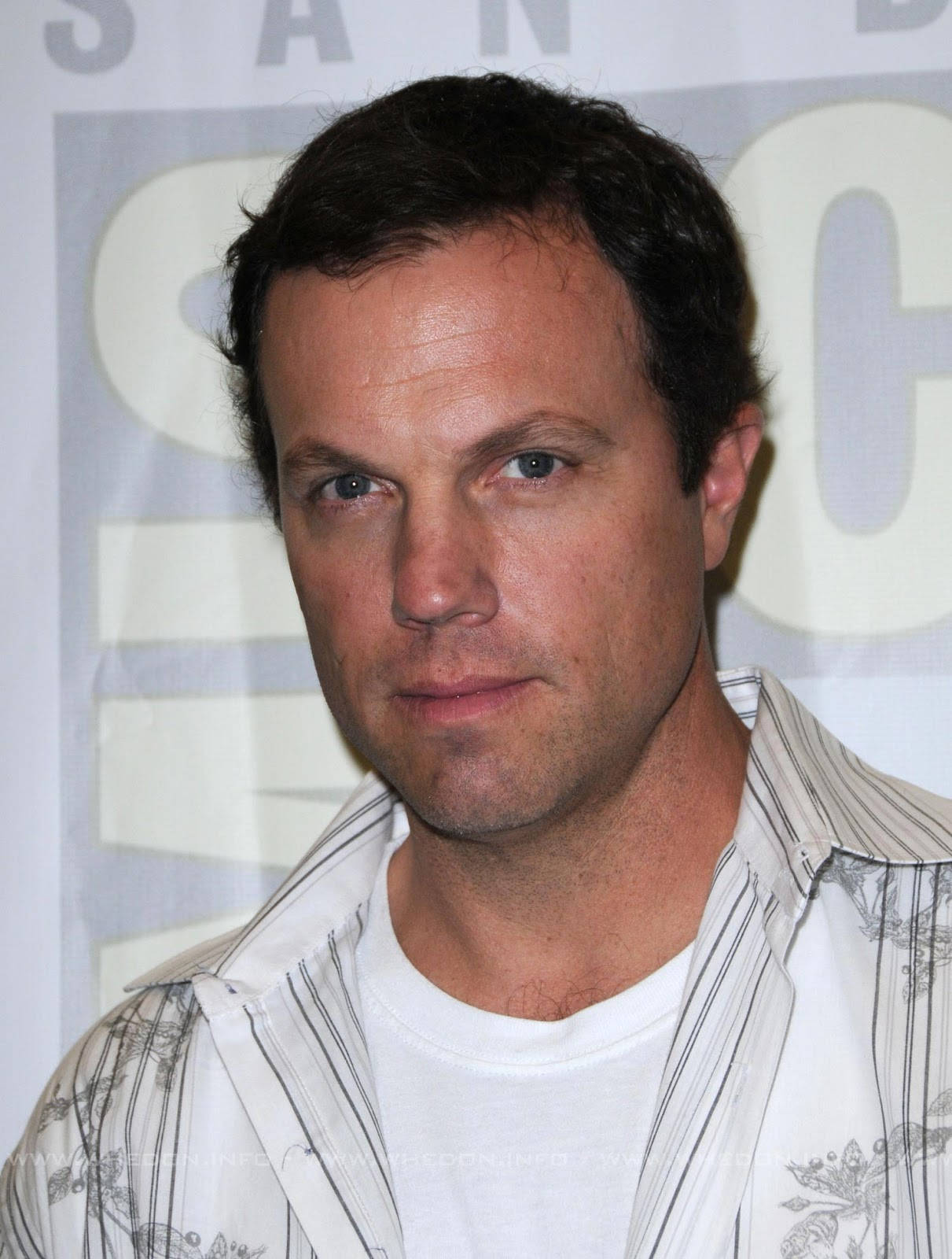 Adam Baldwin Looking Elegant In White Suit Background