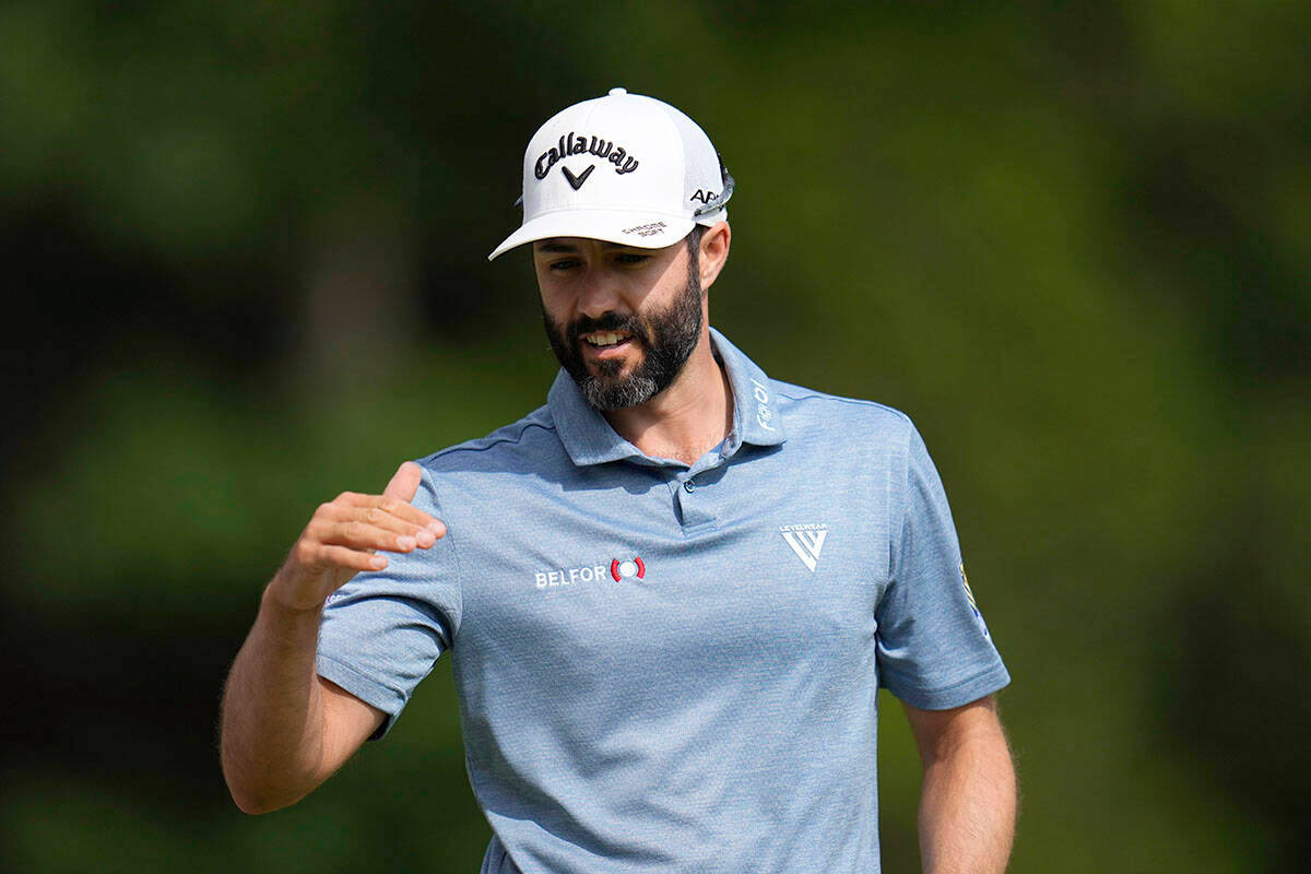 Adam Hadwin Powering A Drive On The Golf Course Background