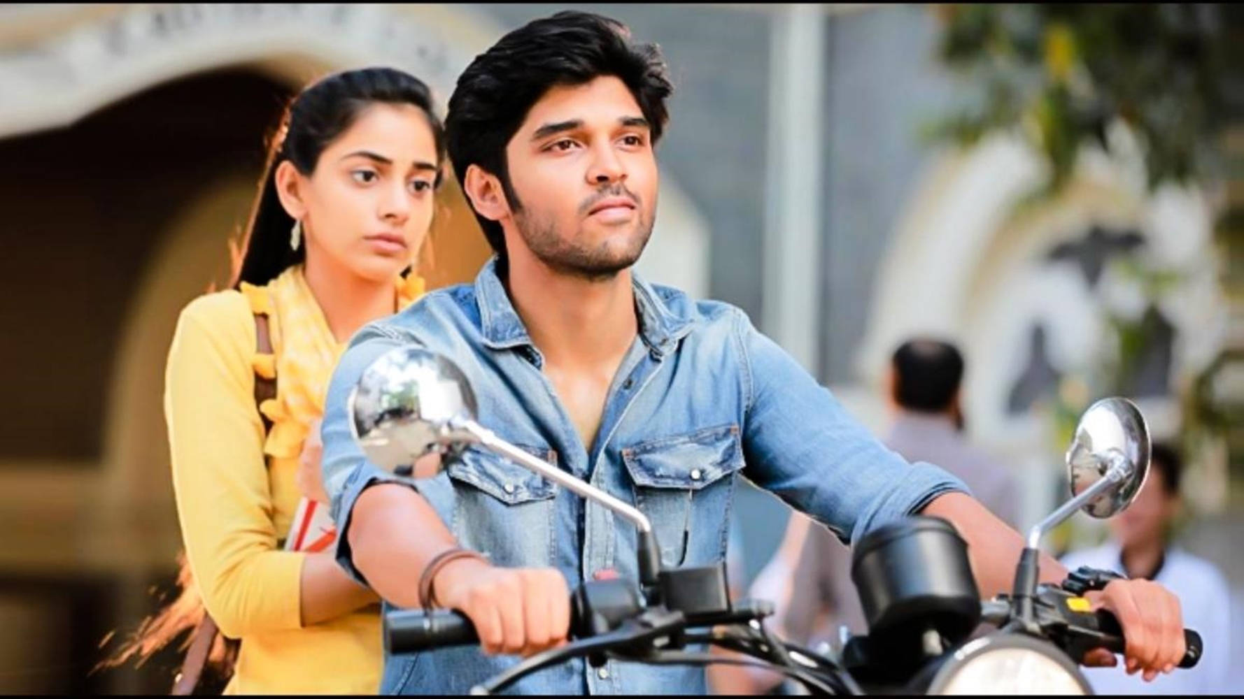 Adithya Varma With Meera Riding A Motorcycle Background