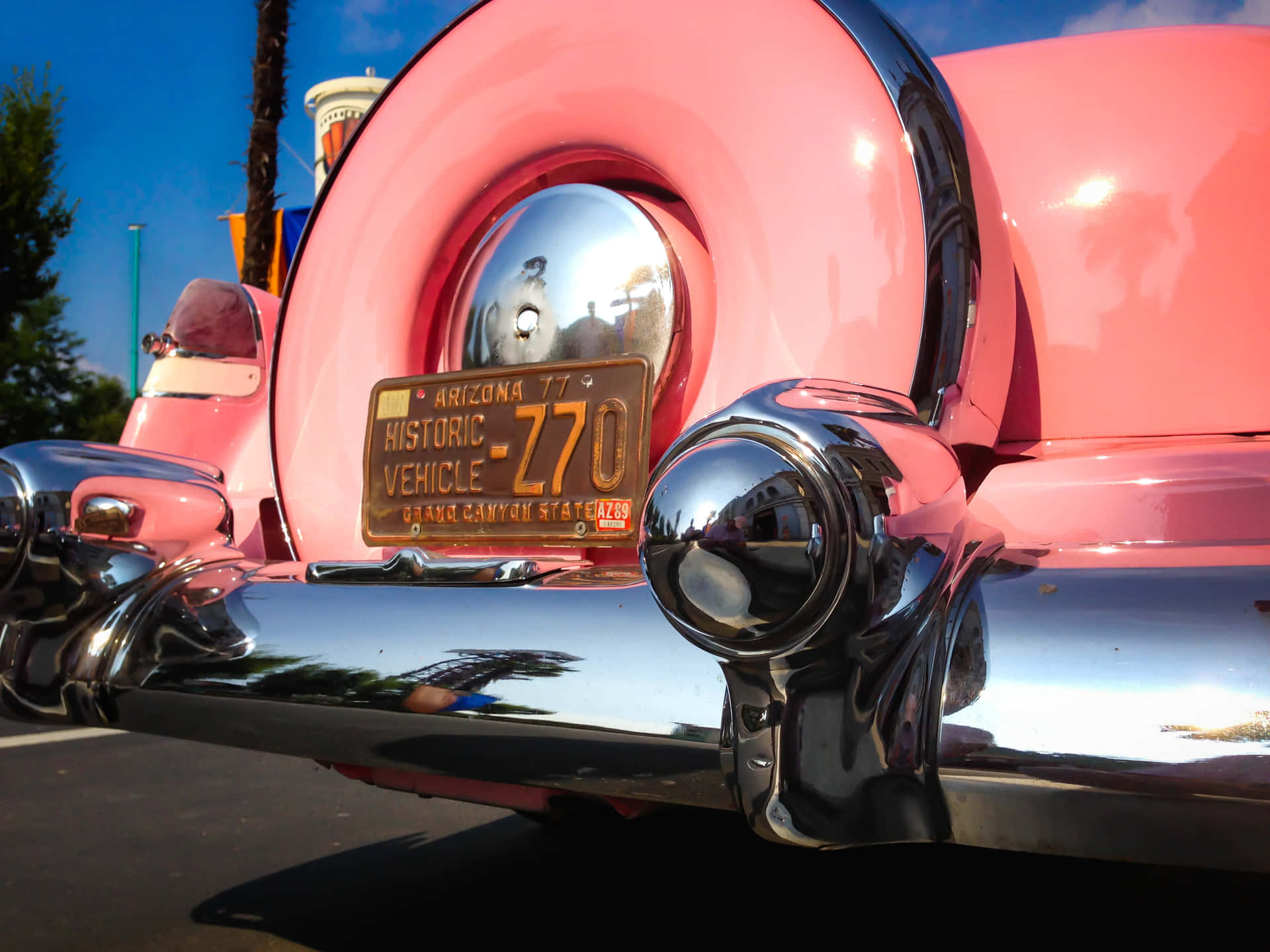 Admiring The Beauty Of A Pink Vintage Car Background