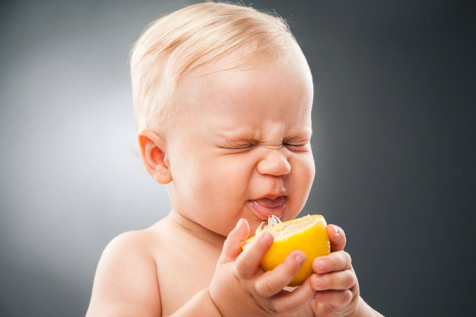 Adorable Baby's Sour Face Background