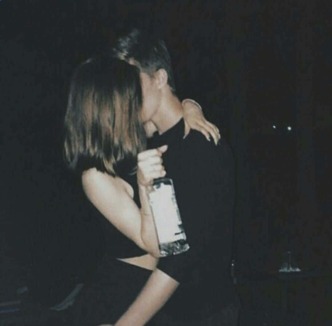Adorable Couple Sharing A Romantic Moment Together Background