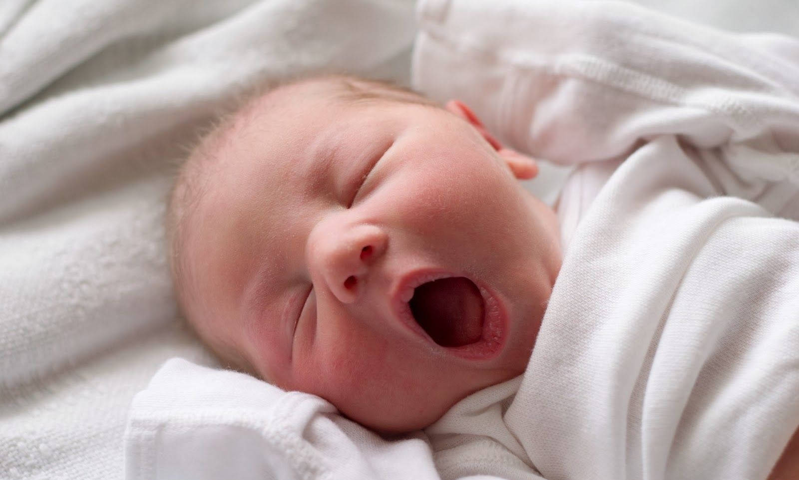 Adorable Newborn Baby Caught Mid-yawn Background