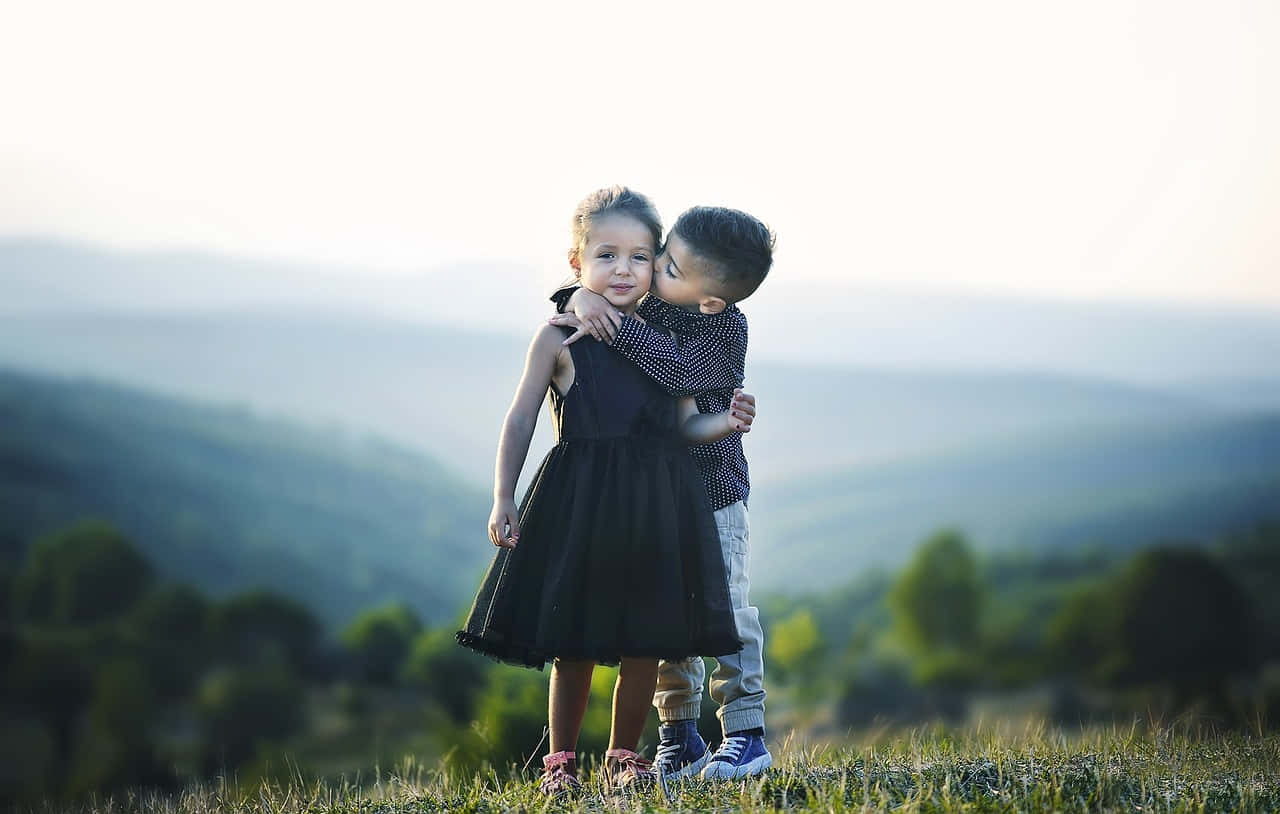 Adorable Photo Of A Tangible Young Boy And A Girl On The Mountain Background