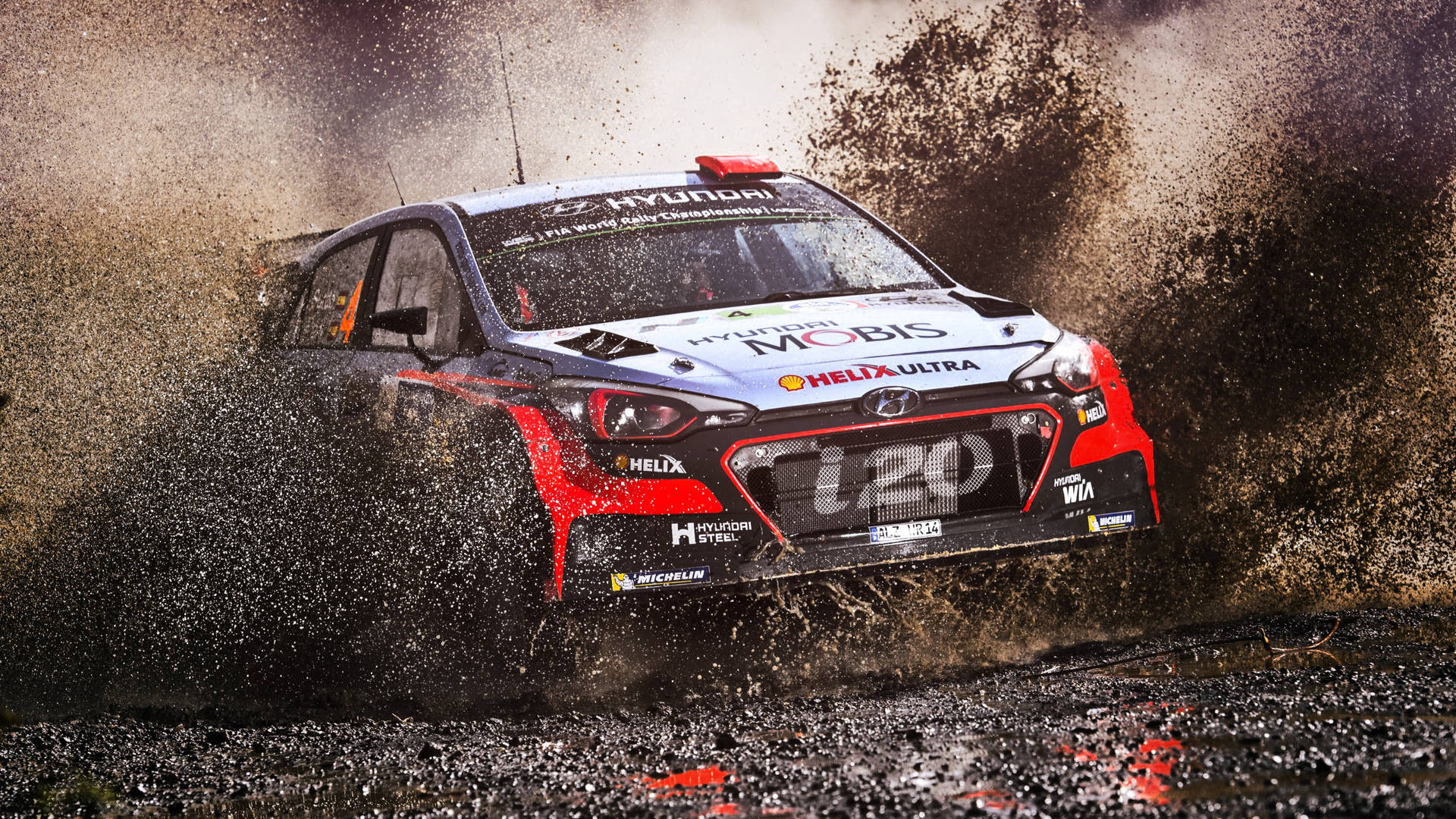 Adrenaline Packed Action - Racing Car Conquering A Muddy Road