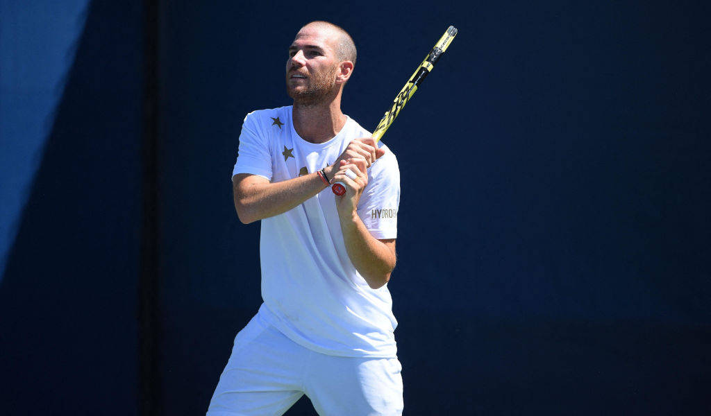 Adrian Mannarino In A Reflective Moment On Court Background