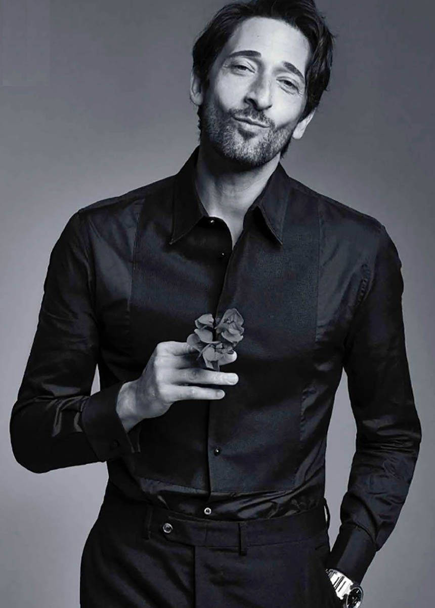 Adrien Brody Holding A Flower Background