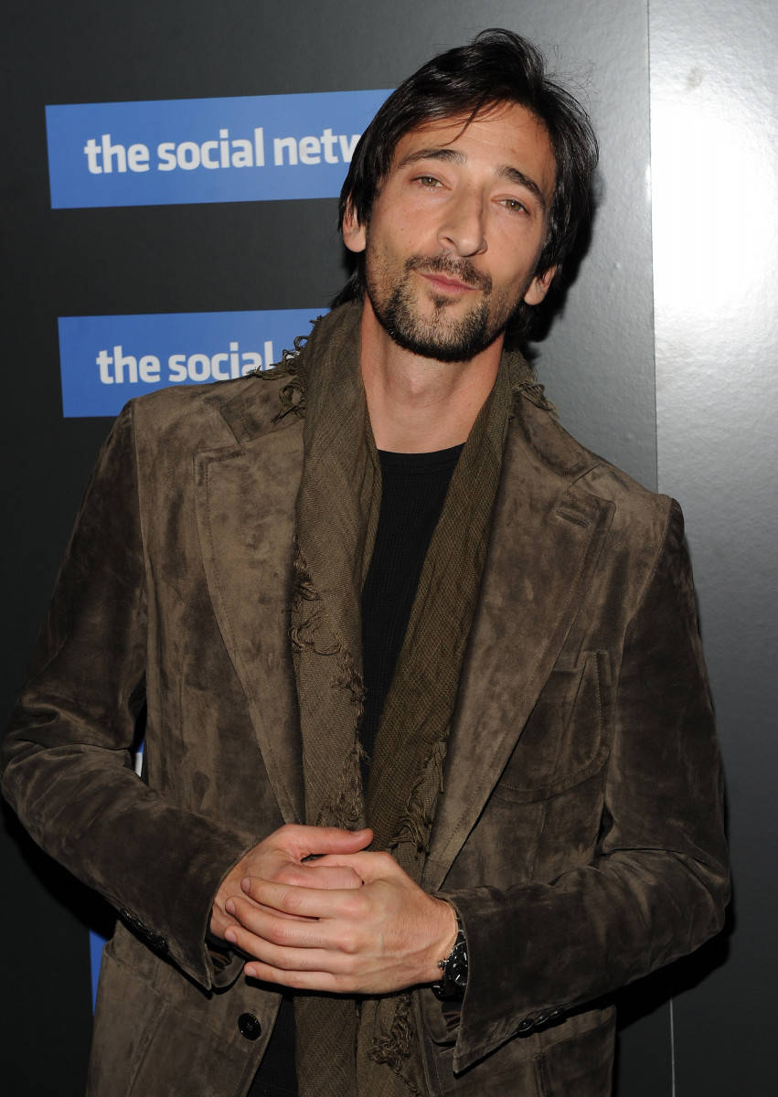 Adrien Brody Wearing A Brown Coat Background