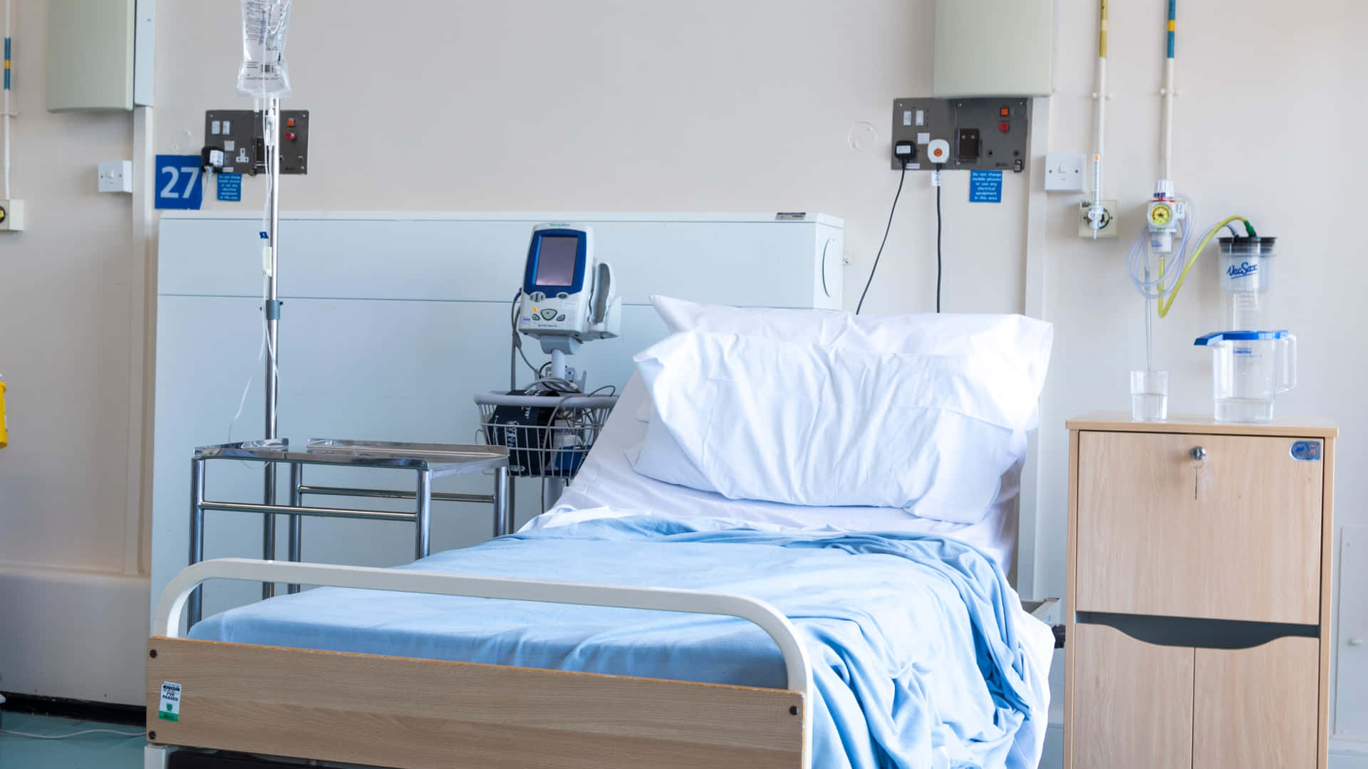 Advanced Hospital Bed Equipped With Medical Apparatus Background