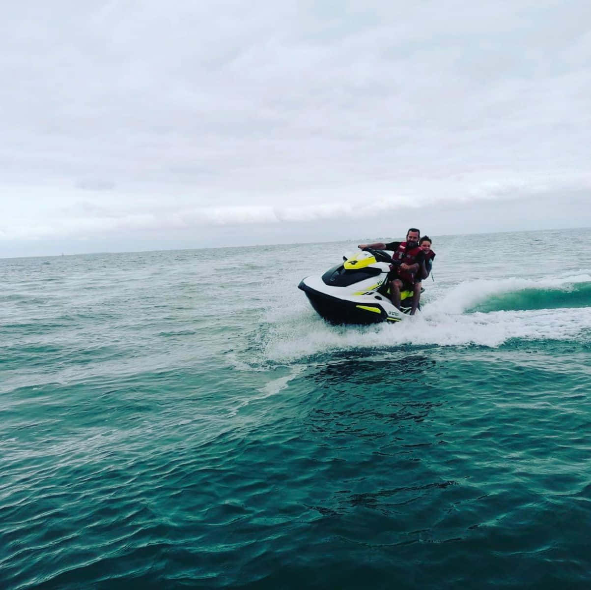 Adventurous Couple Enjoying A Jet Ski Ride Background