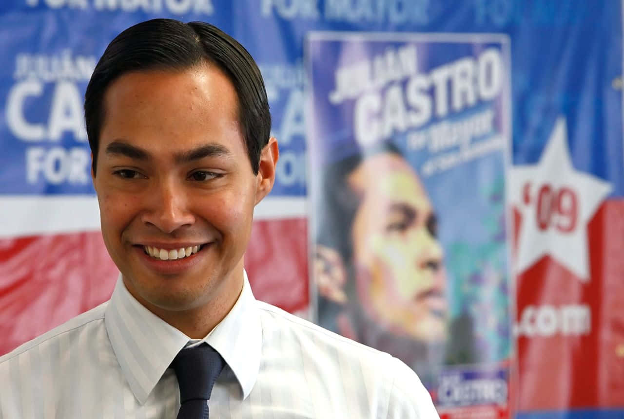 Advocate For Change - Julian Castro Amidst Campaign Posters Background